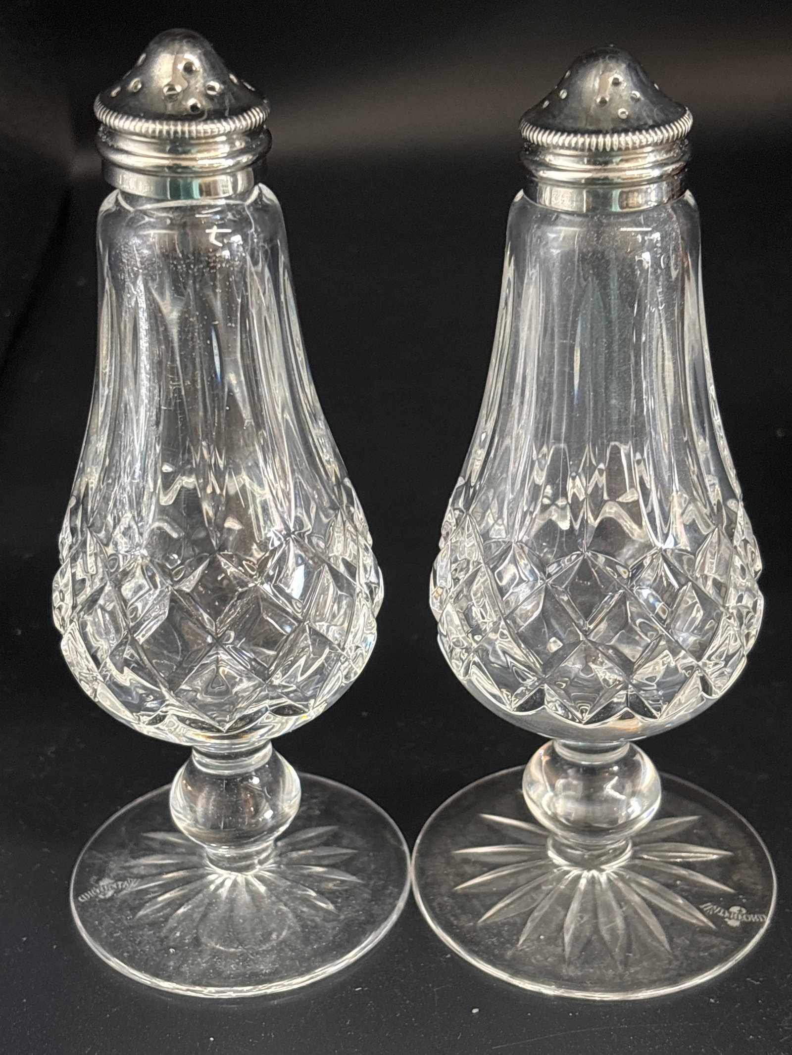pair of vintage Waterford Crystal Lismore 6&1/4 inch salt and pepper shakers: pair of vintage Waterford Crystal salt and pepper shakers in the iconic Lismore pattern. Design: Featuring the classic pear shape, these shakers have diamond and wedge cuts that glint in the light. Ma