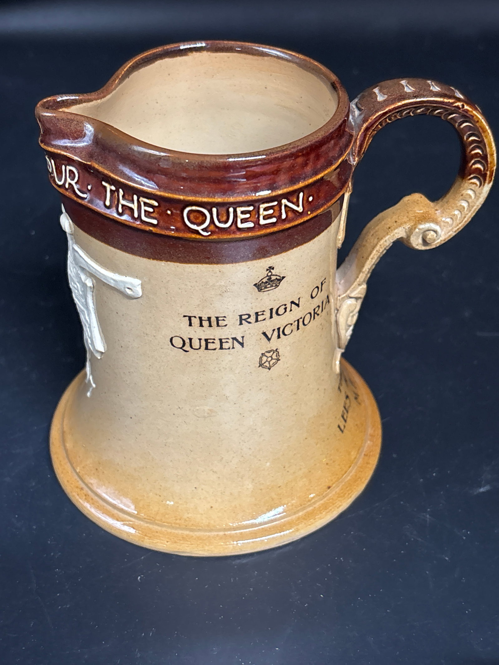 Doulton Lambeth stoneware jug, commemorating Queen Victoria's Diamond Jubilee in 1897: antique Doulton Lambeth stoneware jug, commemorating Queen Victoria's Diamond Jubilee in 1897. It features applied cream-colored friezes with text celebrating the Queen's reign. Similar commemorative