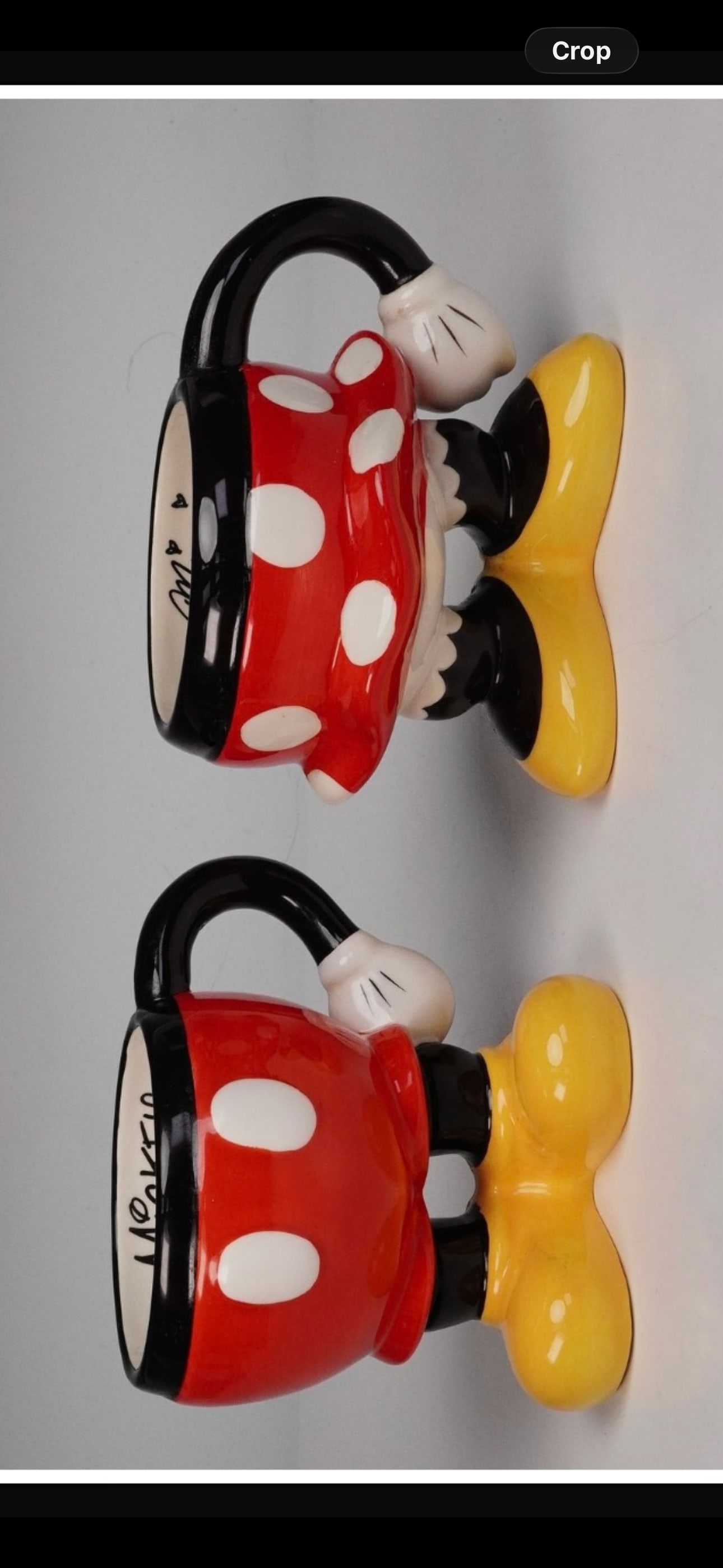 Pair of Disney ceramic mugs of the lower halves of Mickey and Minnie Mouse: Pair of Disney ceramic mugs modeled after the lower halves of Mickey and Minnie Mouse, featuring their iconic red shorts and polka-dotted skirt designs. Each mug is hand-painted with glossy enamel