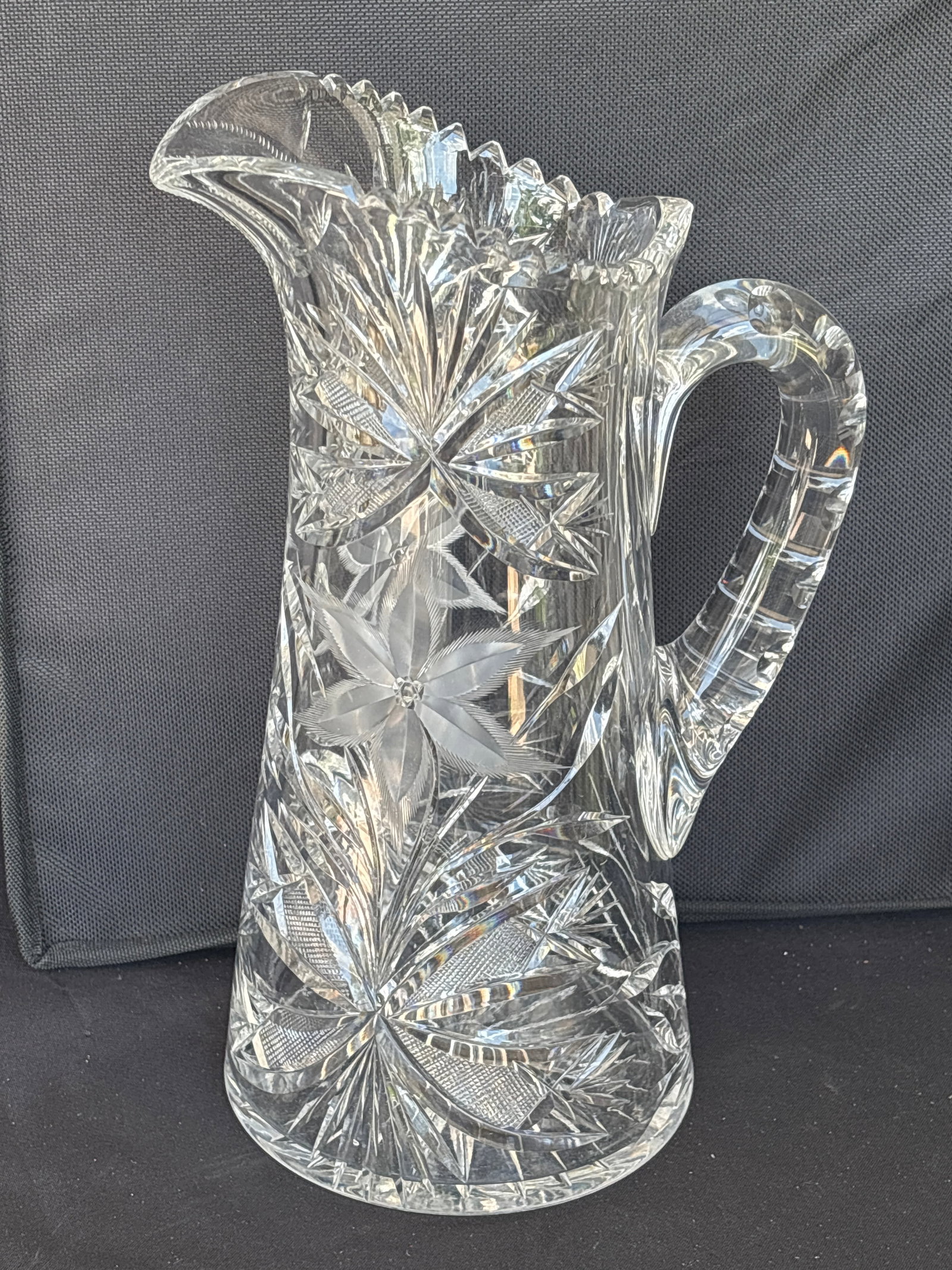 antique 11 inch American Brilliant Period (ABP) cut glass pitcher: antique 11 inch American Brilliant Period (ABP) cut glass pitcher, likely dating from the late 19th to early 20th century. Pattern: Features intricate geometric and floral designs, commonly
