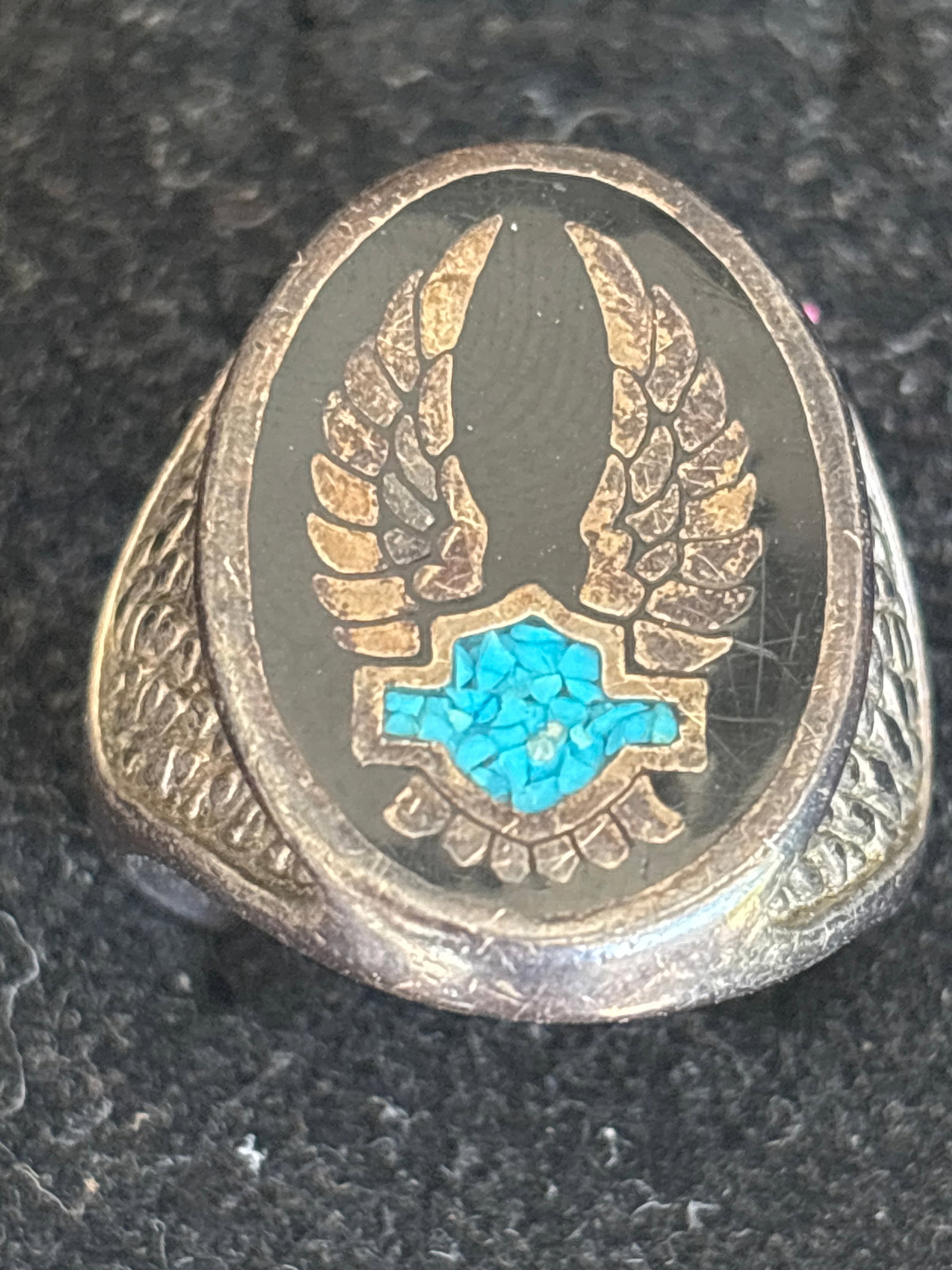 vintage sterling silver Harley-Davidson-style eagle biker ring: vintage Harley-Davidson-style eagle biker ring. It features a central eagle design with its wings extended upwards and a shield emblem at the bottom.Key FeaturesMaterials: Typically crafted from