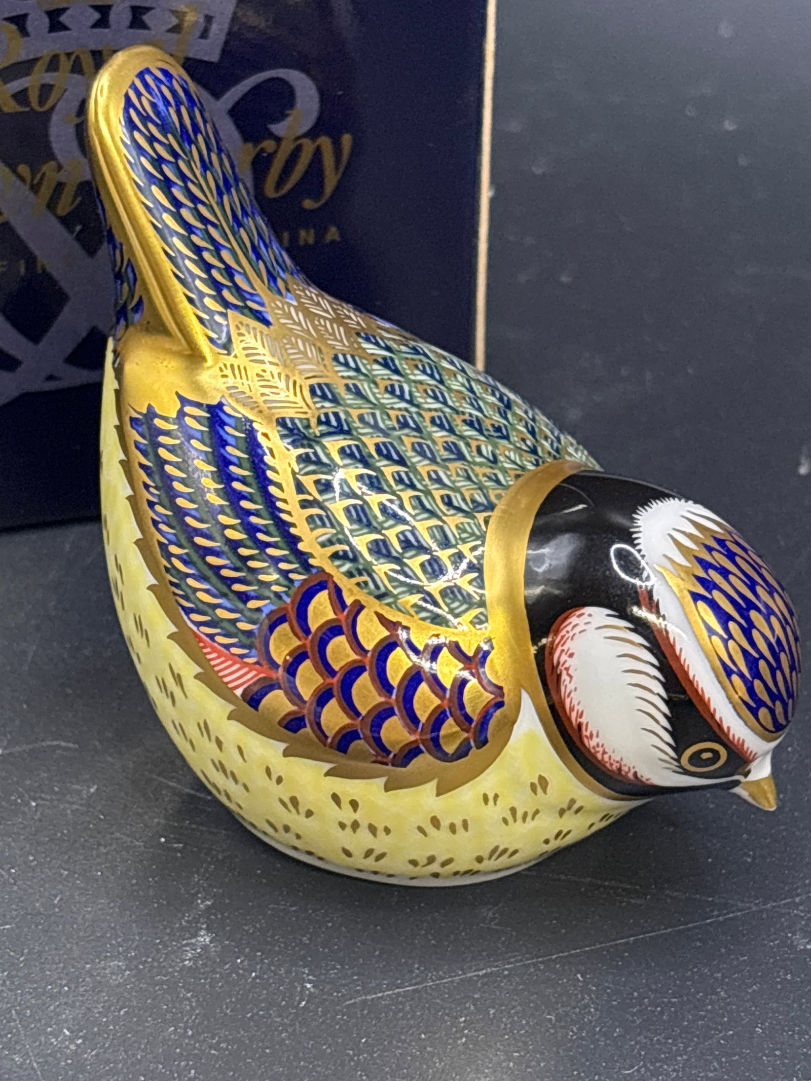 Small Royal Crown Derby Blue Tit bone china 2.75 inches paperweight: Gold stopper, with box. Royal Crown Derby Blue Tit Imari paperweight.This figurine features traditional Imari colors of blue, red, and gold, and stands approximately 2 3/4 inches tall.It was introduce