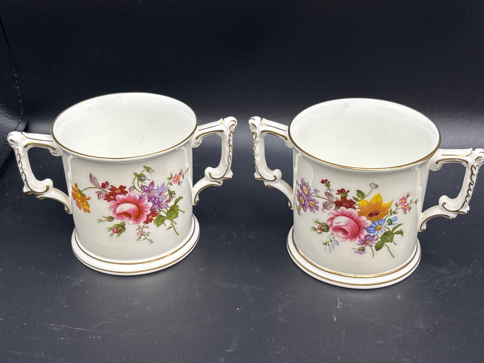 Pair 3 inch Royal Crown Derby "Derby Posies" Loving Cups: Pair a Royal Crown Derby "Derby Posies" Loving Cups, a traditional two-handled porcelain vessel often used for celebratory or commemorative purposes.Key DetailsMaker: Royal Crown Derby (English fine b