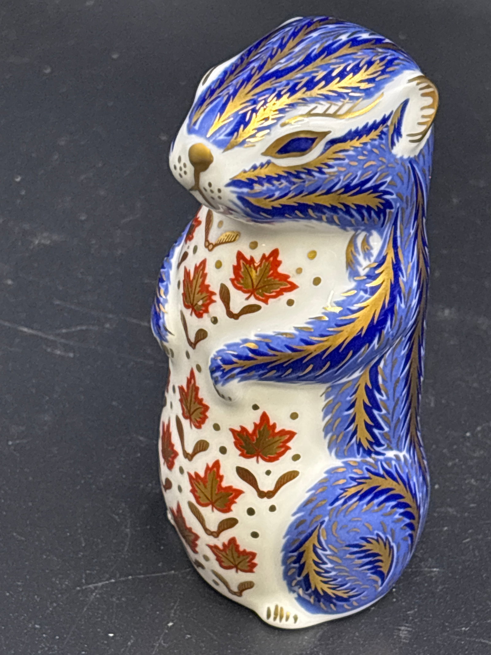 Nice 4 inch Royal Crown Derby Blue Chipmunk paperweight: Gold stopper, no box. Royal Crown Derby Chipmunk fine bone china paperweight.This collectible figurine features the brand's signature Imari style with hand-painted patterns in orange, cobalt blue, and