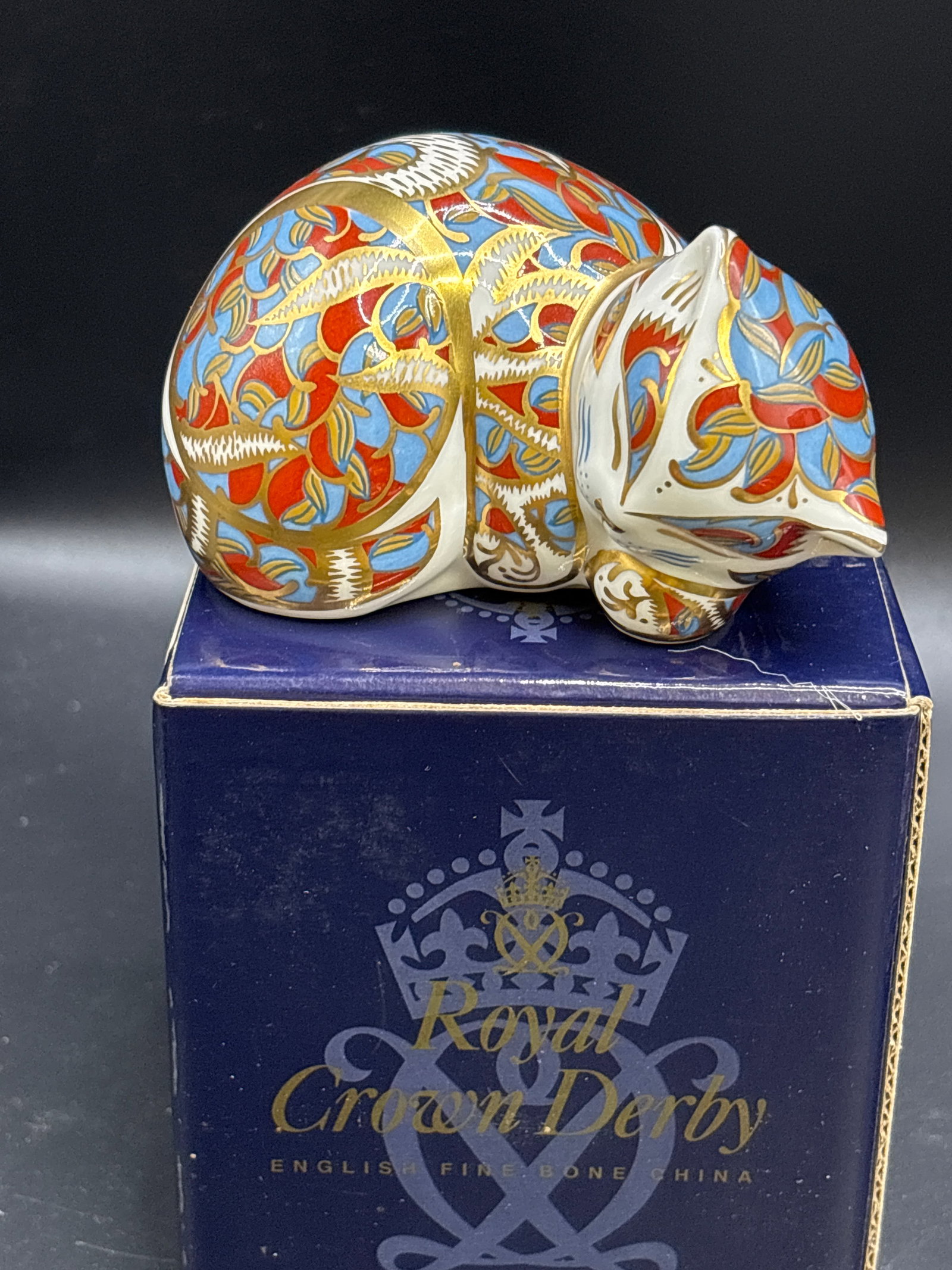 Imari ‘Contented Kitten’ Royal Crown Derby bone china paperweight: Gold stopper, with box. "Contented Kitten” paperweight by Royal Crown Derby. This piece is crafted from fine bone china and is part of the brand's celebrated collection of animal paperweights.Pr
