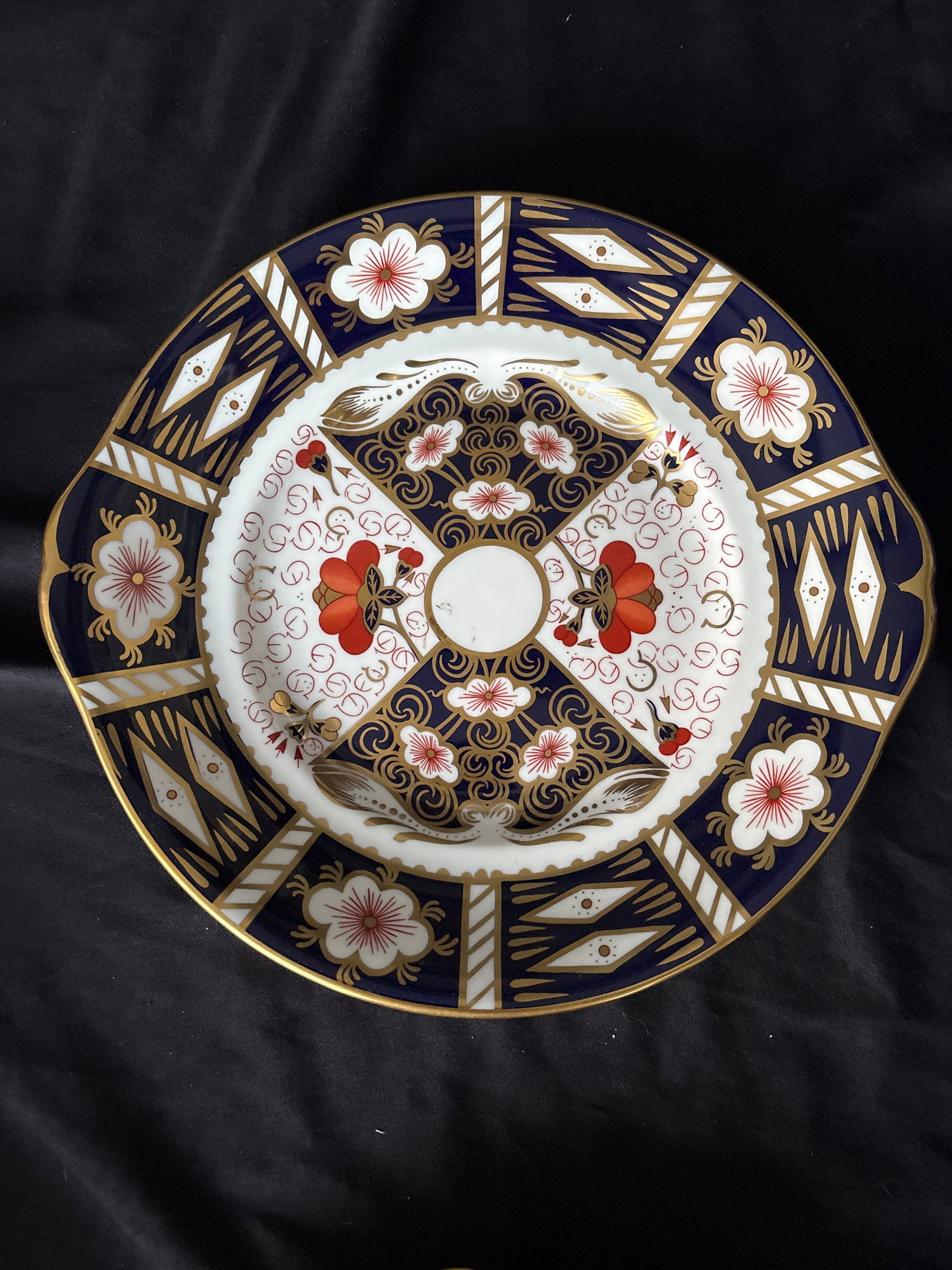 Royal Crown Derby traditional Imari #2451 pattern 10 inch dessert plate: Royal Crown Derby "Traditional Imari" (Pattern 2451) fine bone china plate. Originating from England, this distinctive style features a geometric cobalt blue border, rust-orange floral ironwork, and i