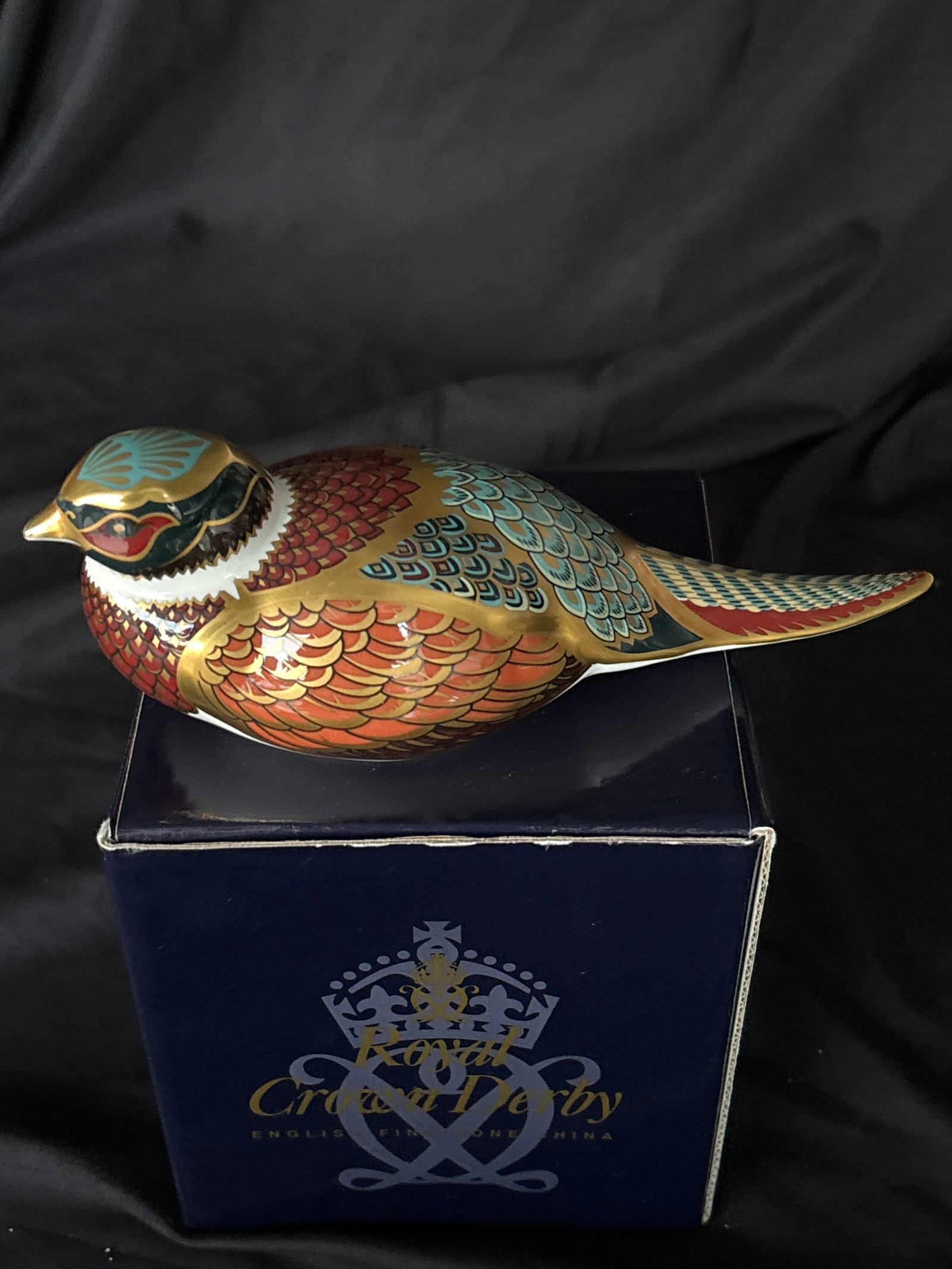 1998 Collectors Guild Royal Crown Derby Woodland Pheasant 7 inch ppaperweight: Gorgeous Royal Crown Derby Imari Woodland Pheasant paperweight.Design: It features stylized feathering in rust, cobalt blue, and white with 22-karat gold accents.Collector's Item: This specific model 