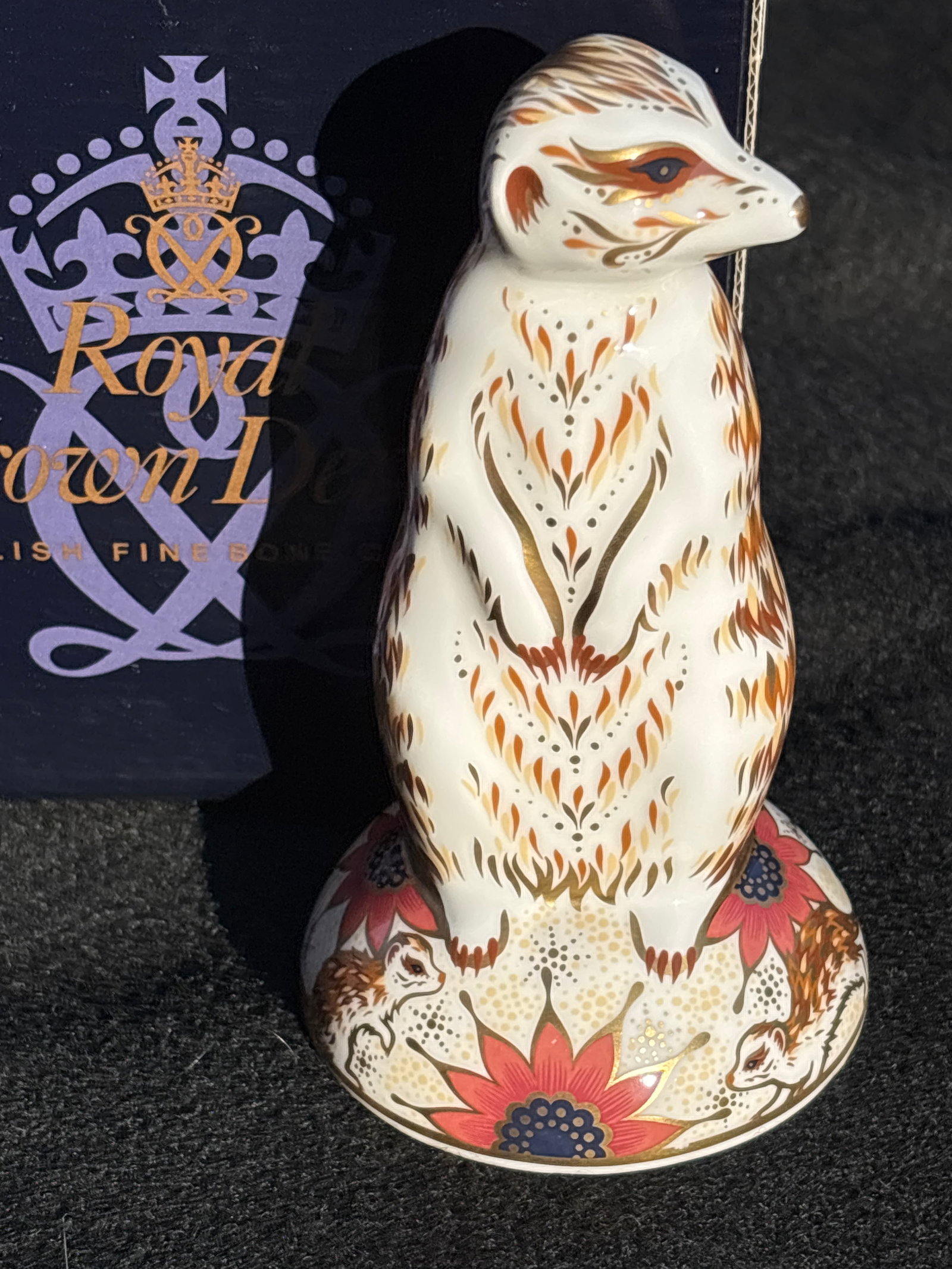 Royal Crown Derby Imari Meerkat bone china 5.25 inch paperweight.: With box. Silver stopper. Royal Crown Derby Imari Meerkat porcelain paperweight.Design Details: It features a white bone china body decorated with a traditional Imari pattern in gold and red.Specifica