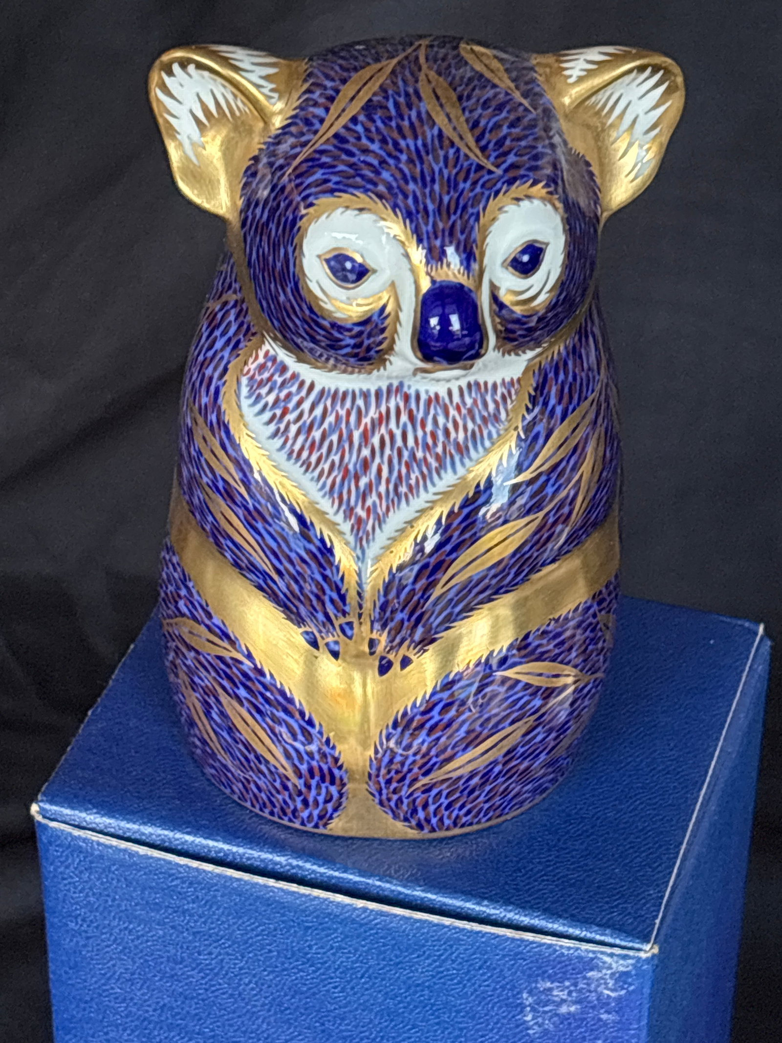 Koala Royal Crown Derby Australia Collection 4&1/2 inch paperweight: Gold stopper. With box. Royal Crown Derby Koala bear paperweight. Design Details: It features a navy blue Imari pattern with detailed 22-carat gold accents throughout.Physical Features: The figurine s
