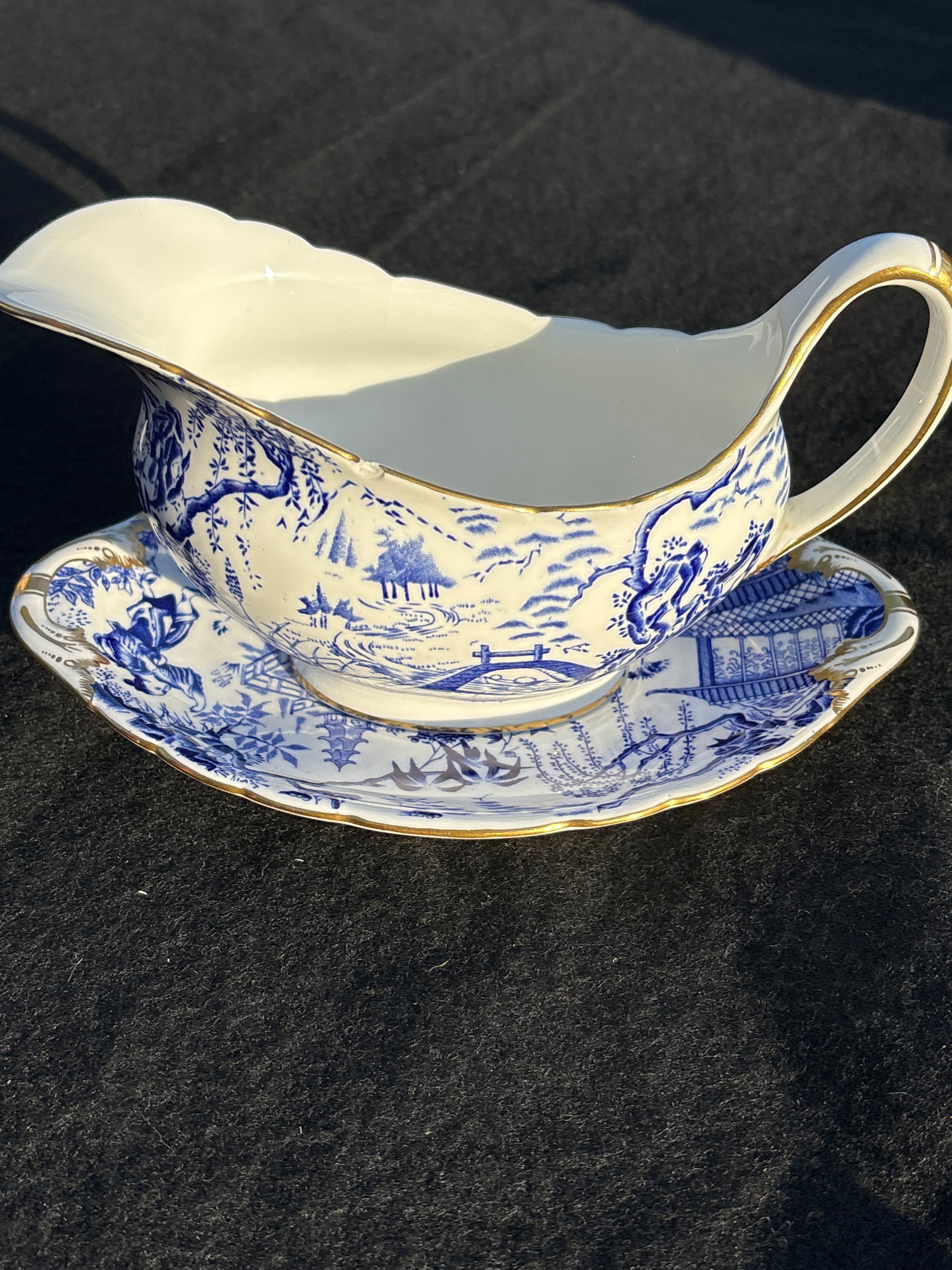 Gravy on underplate Royal Crown Derby in the popular "Mikado" pattern: 8 inch: Royal Crown Derby in the popular "Mikado" pattern. This classic design features a blue transferware scene of pagodas, bamboo, and bridges, inspired by traditional Japanese art. 2&3/4 cups and saucers 