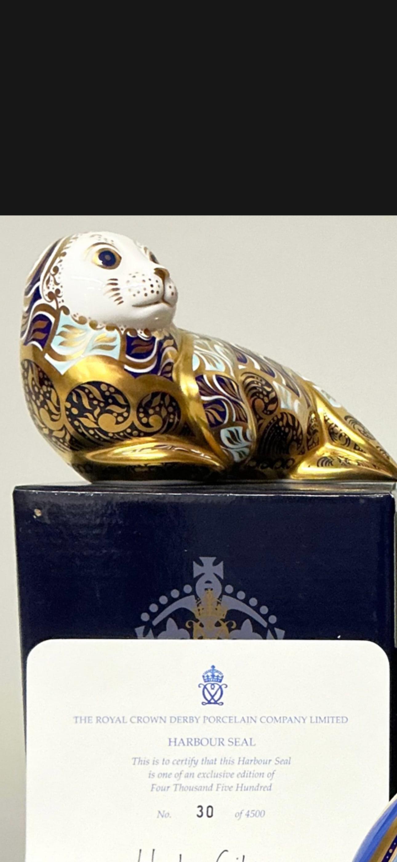 Artist signed Exclusive Harbour Seal Royal Crown Derby 5 inch paperweight: Gold stopper. Royal Crown Derby paperweight, Harbour seal, exclusive limited edition 30/4,500, gold stopper, 12.5cm long, signed in gold by designer Tien Manh Dinh, printed mark in red, certificate, b