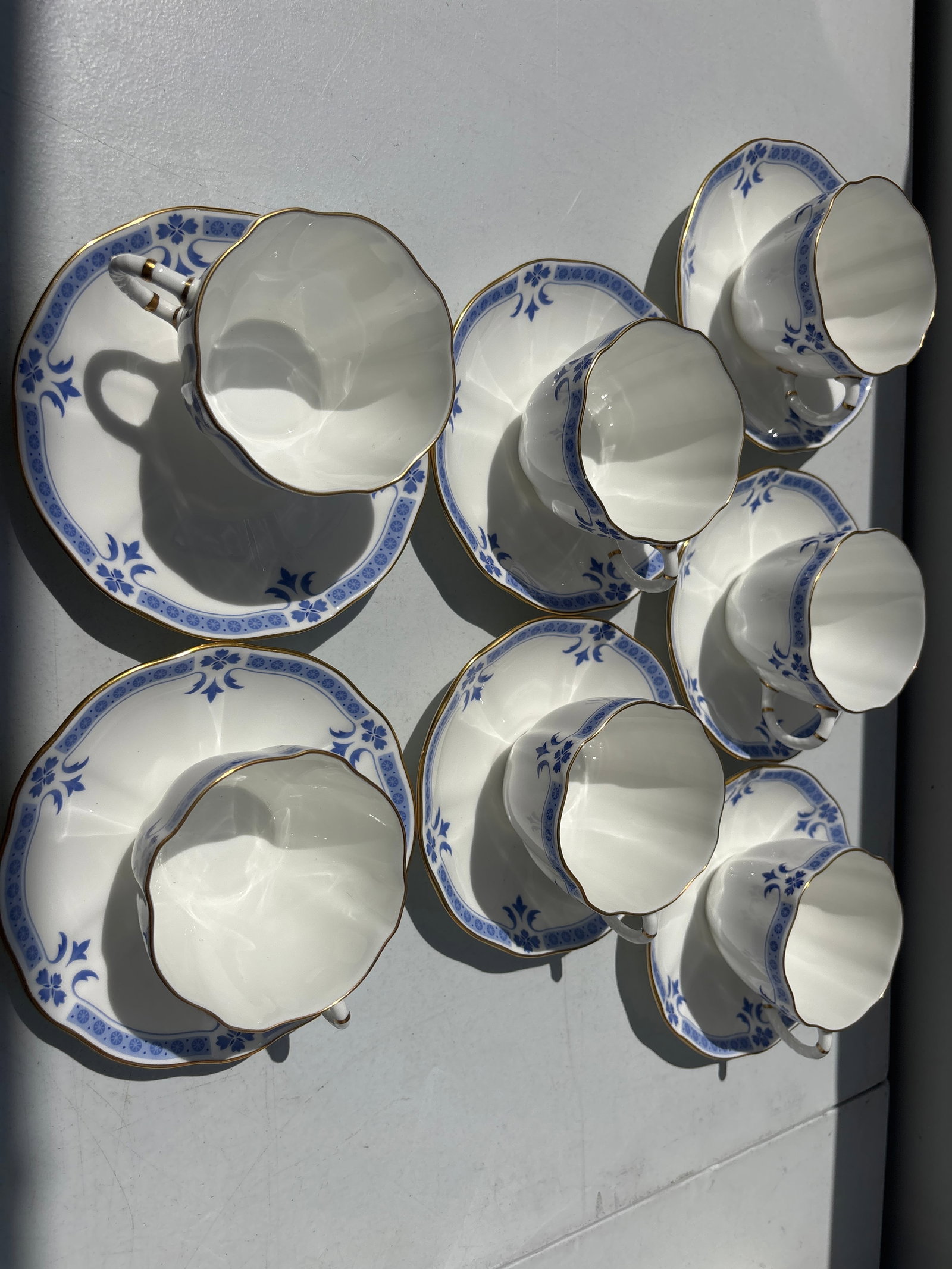 First quality Set of seven Royal Crown Derby "Grenville" pattern cups with saucers: Set of seven Royal Crown Derby "Grenville" A.1303 pattern cups with saucers, a classic English fine bone china design.The pattern is characterized by its Surrey shape with scalloped edges, featuring a