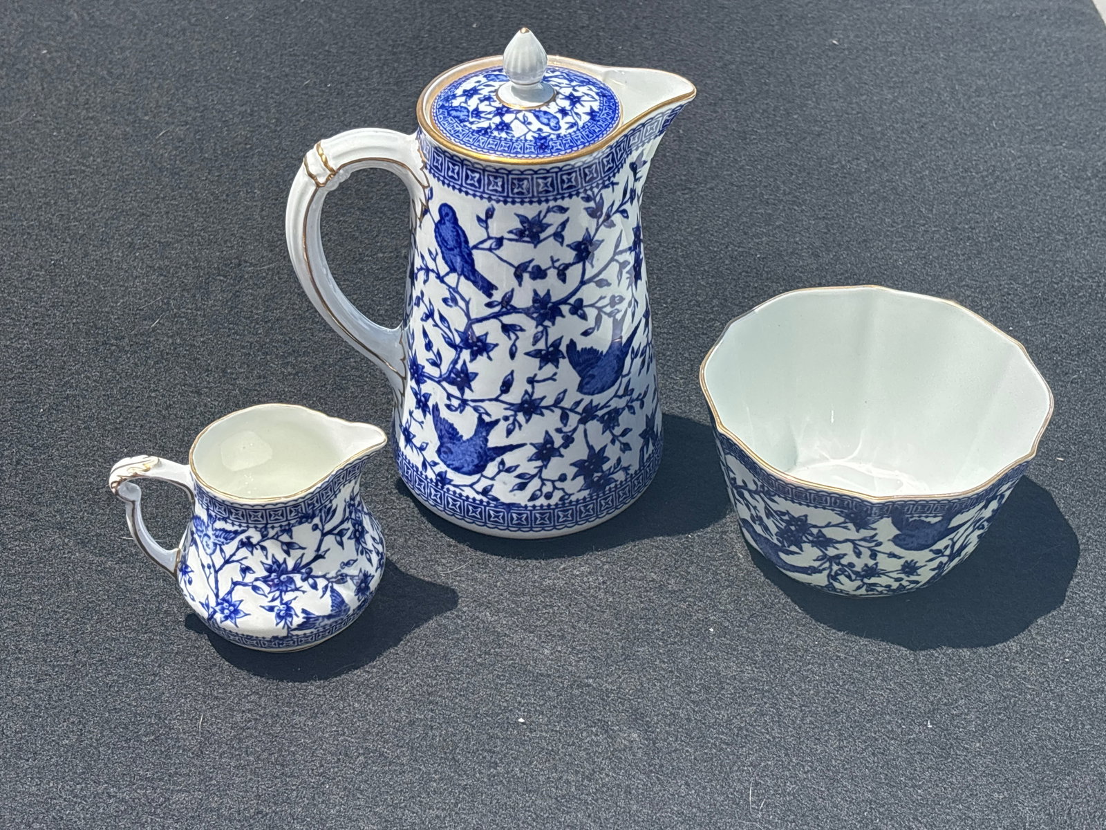 Rare Royal Crown Derby porcelain Pembroke pattern three piece coffee set: Royal Crown Derby porcelain in the Pembroke pattern (specifically the Blue Pembroke or Pembroke Blue variation). Key Features of the PlatePattern Name: Pembroke.Design: A Chinoiserie-style pattern fea