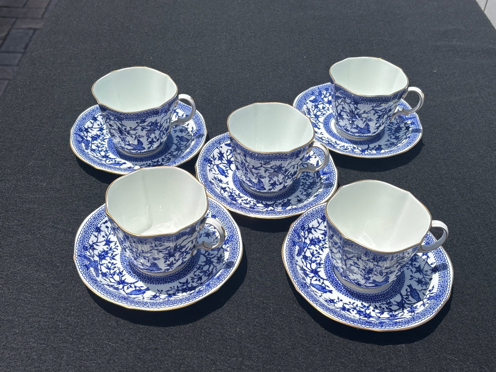 Set of five Royal Crown Derby porcelain Pembroke pattern tea cups with saucers: Royal Crown Derby porcelain in the Pembroke pattern (specifically the Blue Pembroke or Pembroke Blue variation). Key Features of the PlatePattern Name: Pembroke.Design: A Chinoiserie-style pattern fea