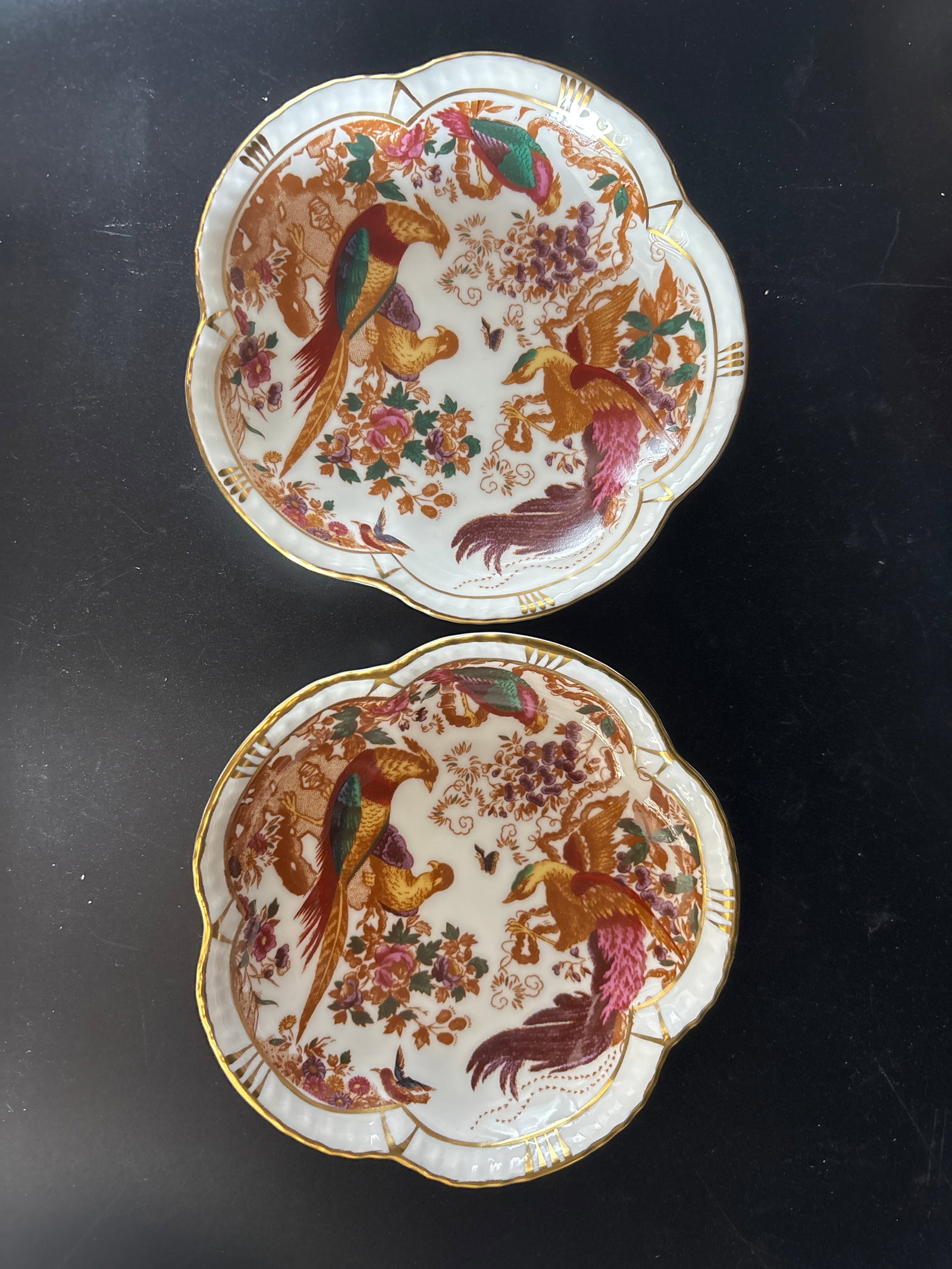 Pair 1st quality Royal Crown Derby "Olde Avesbury" collection 4&1/2 inch dishes: Pair Royal Crown Derby "Olde Avesbury" collection. The pattern features a vibrant scene of exotic birds and floral motifs, a design that dates back to 1932. This specific piece is made of fine English