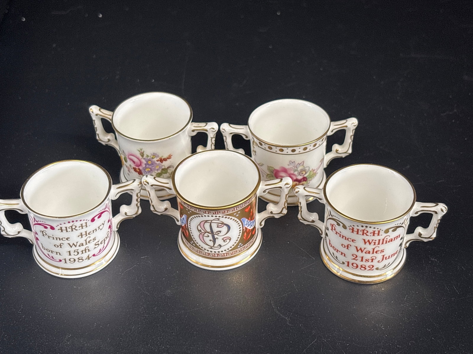 Five various mini loving cups Royal Crown Derby fine bone china 1inch: Five various mini loving cups including Prince Henry, Prince William, two Posies and Royal Crown Derby commemorative miniature loving cup, likely celebrating a British Royal event such as the 1997 Gol