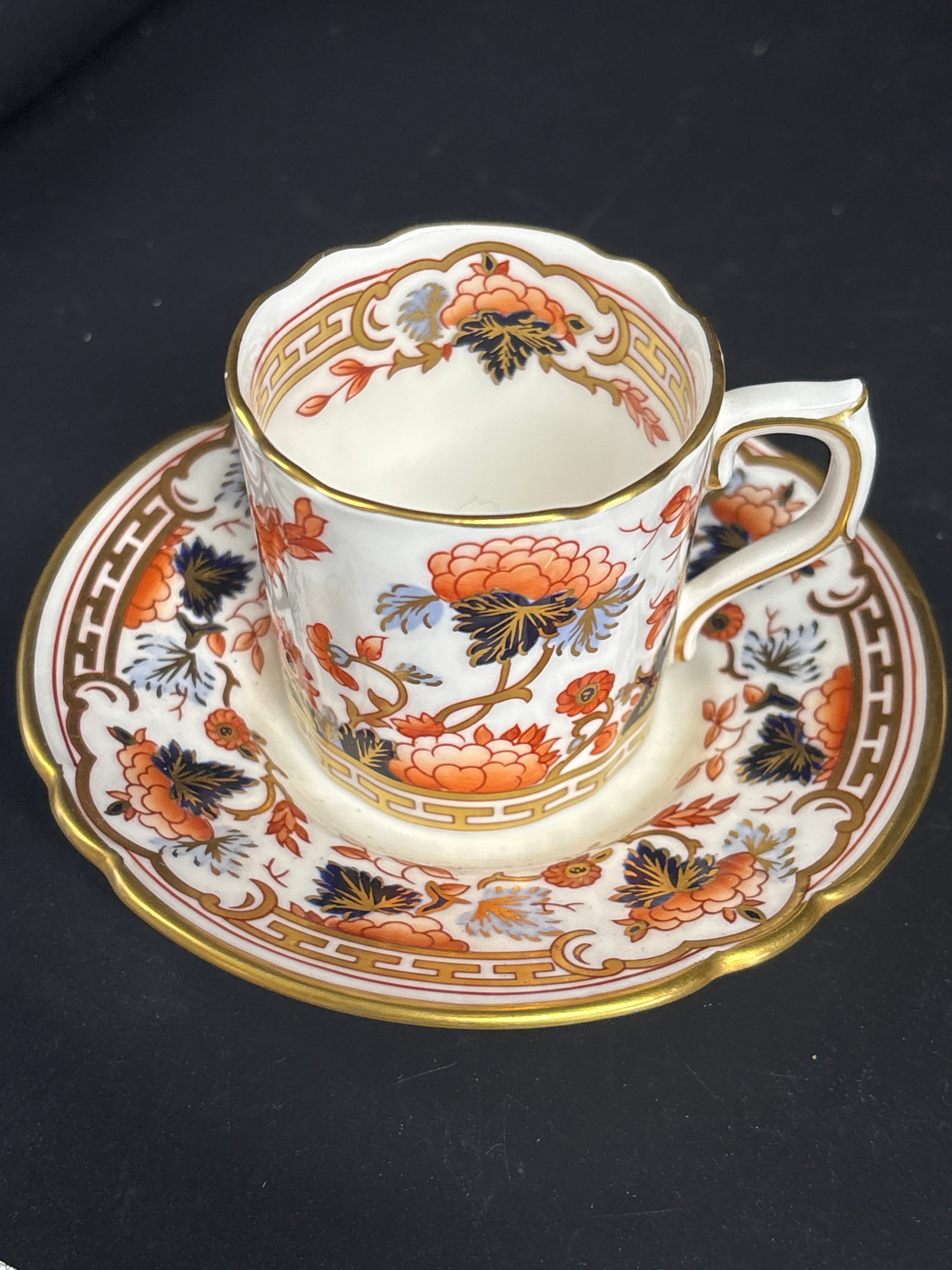 Antique Royal Crown Derby fine bone china demitasse cup and saucer: fine bone china demitasse cup and saucer is an antique or vintage piece from Royal Crown Derby, characterized by its opulent Imari-style pattern.Pattern DetailsThe design is a variation of the traditi
