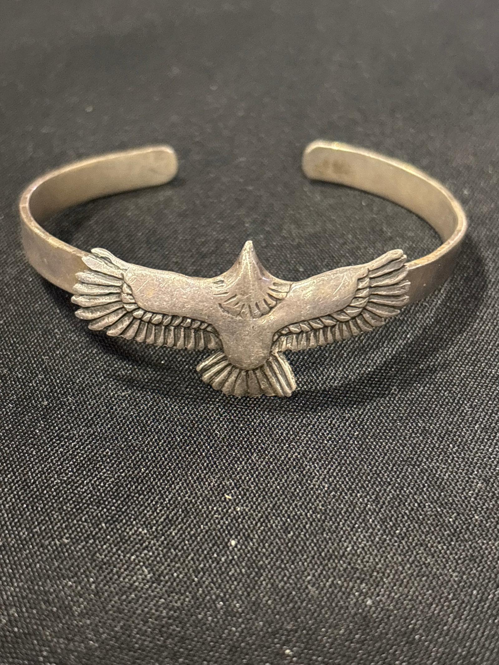 Vintage .925 silver handcrafted soaring eagle design cuff bracelet; 22 grams: silver eagle cuff bracelet, featuring a detailed soaring eagle design with outspread wings that form the front of the cuff. This style of jewelry is often associated with Native American-inspired or S