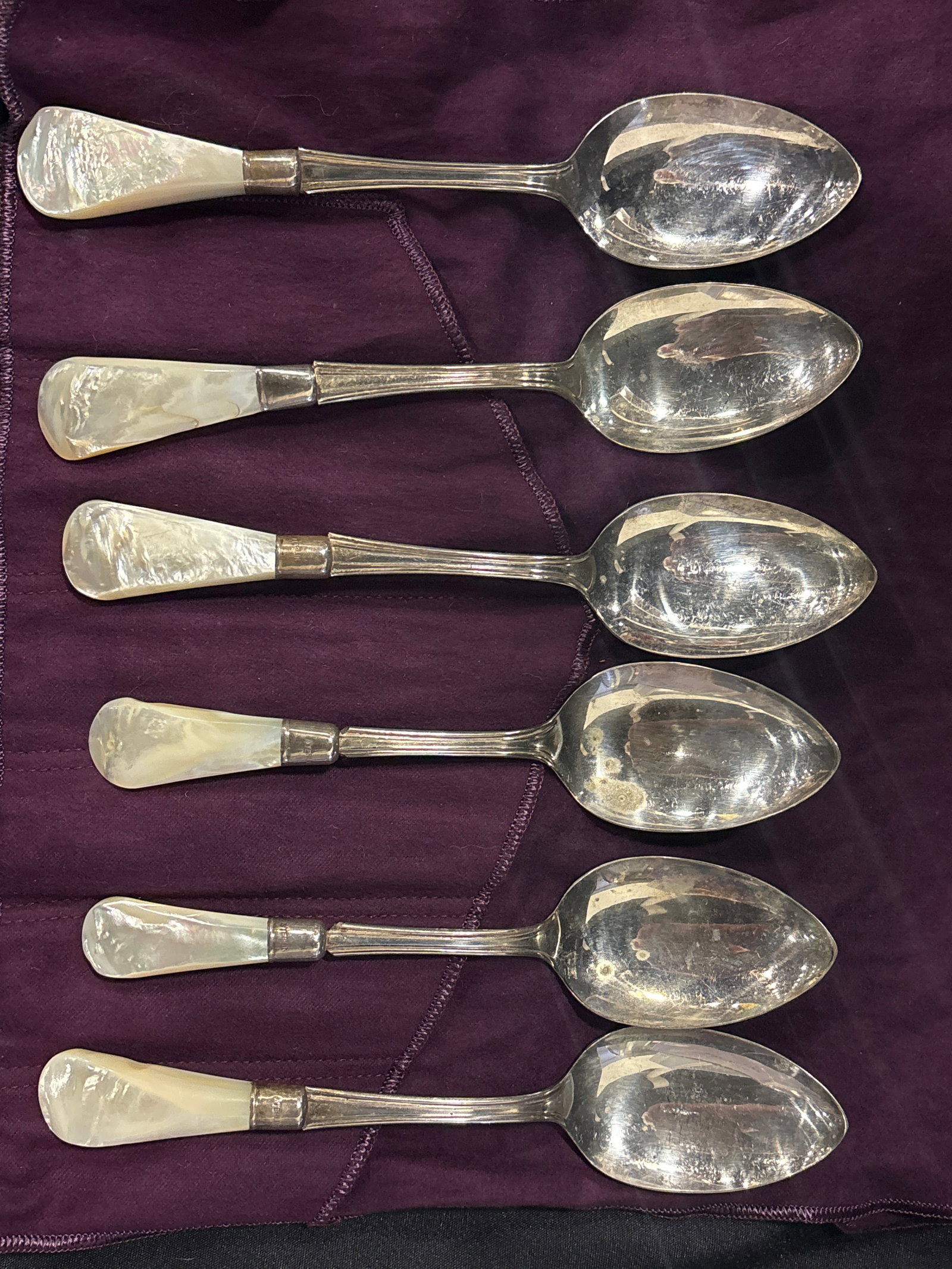 antique spoons feature silver ferrules & silver-plated bowls &mother-of-pearl handles: antique spoons feature silver or silver-plated bowls and distinct mother-of-pearl handles, likely dating from the late 19th to early 20th century. They are commonly identified as grapefruit or citrus 