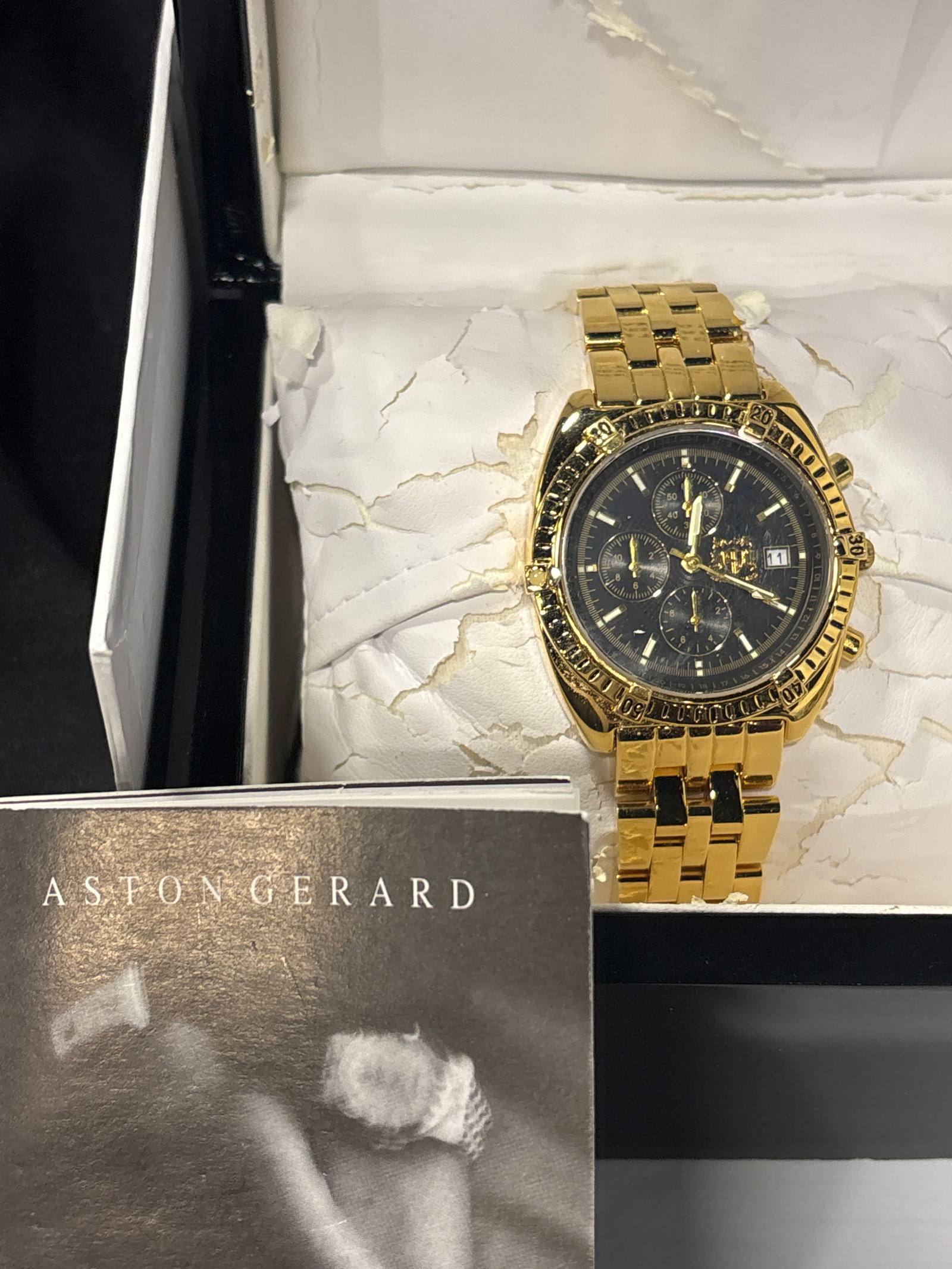 Aston Gerard Chronograph watch model 130939KM: Aston Gerard Chronograph, specifically identified as model 130939KM. This timepiece features an 18ct gold electroplated finish and is often marketed as being set with diamonds. Key SpecificationsModel