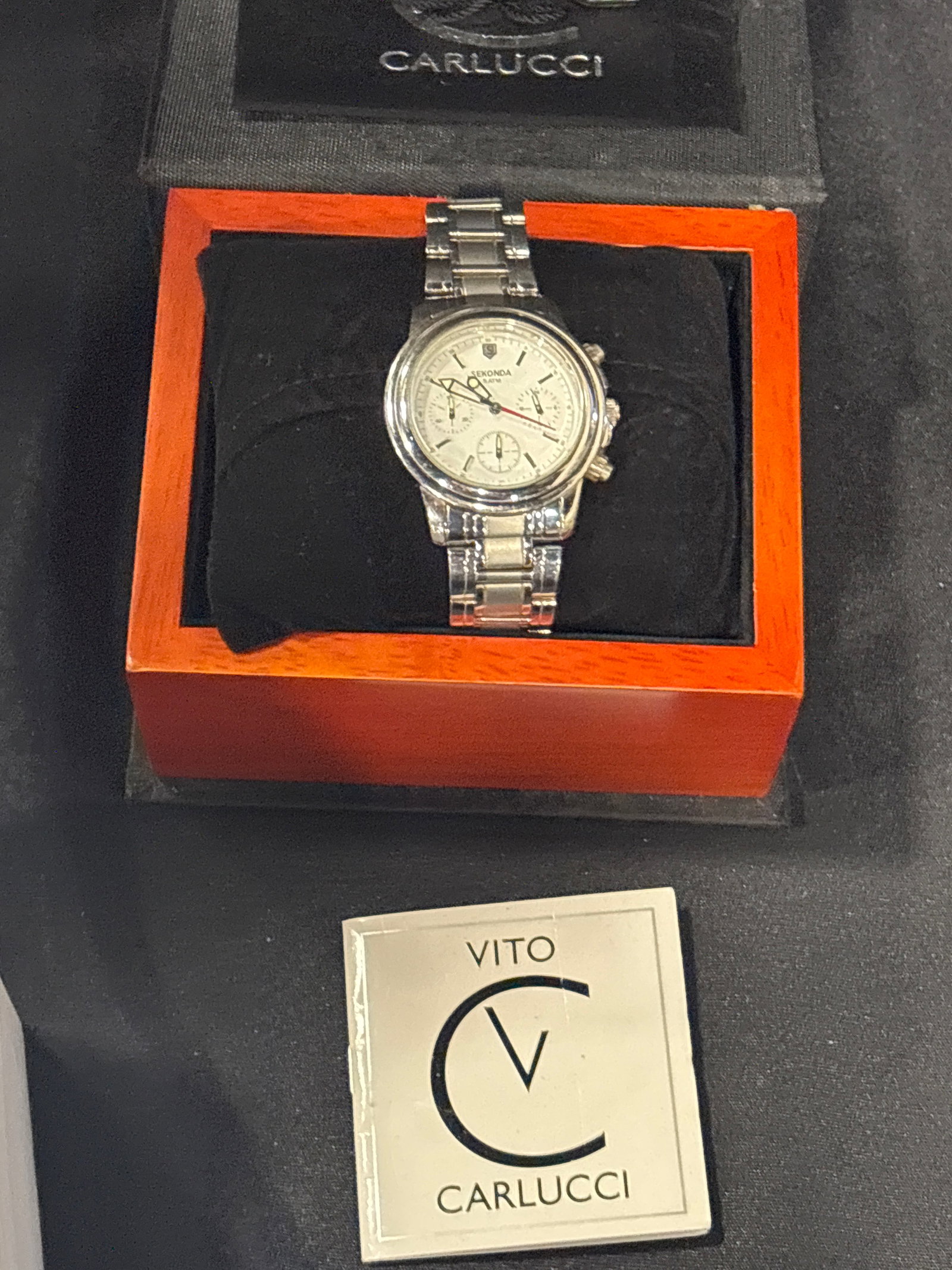 Sekonda Chronograph men's watch, featuring a silver-colored stainless steel case: Sekonda Chronograph men's watch, featuring a silver-colored stainless steel case and matching bracelet. It is marked with "5 ATM," indicating it is water-resistant up to 50 meters. Eberhard & Co Watch
