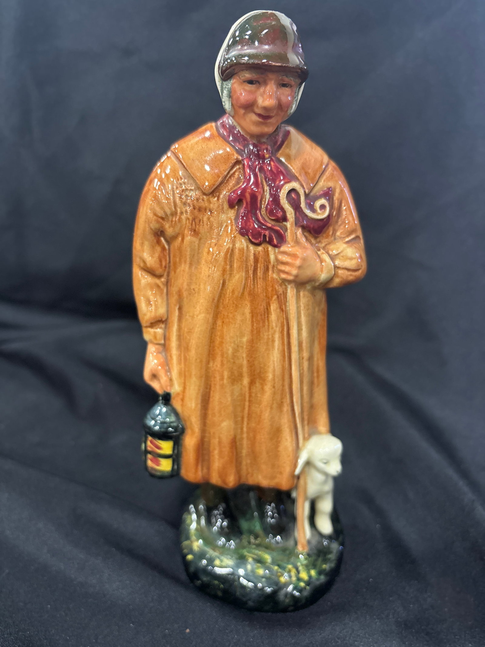 vintage Royal Doulton figurine titled "The Shepherd," model number HN1975: vintage Royal Doulton figurine titled "The Shepherd," model number HN1975. Designer: Designed by Harry Fenton. Production Era: Produced between 1945 and 1975. Features: Features a shepherd in a brown 