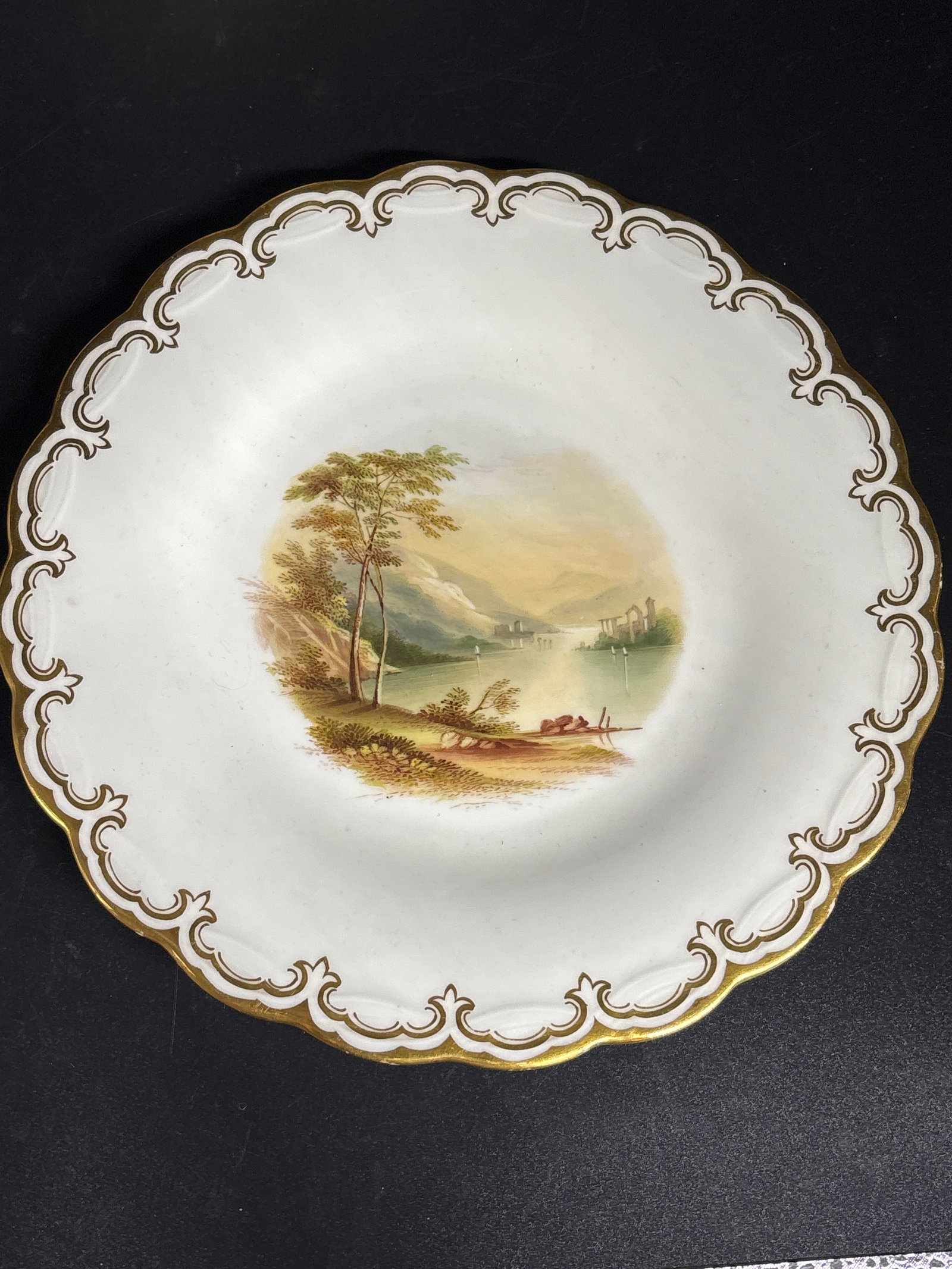 19th C. Minton English Biedermeier hand painted 9 inch porcelain plate: Minton English Biedermeier porcelain plate featuring a hand-painted landscape scene and a gold chain edge, likely dating back to around 1880. Type: Hand-painted porcelain plate.Design: Landscape scene