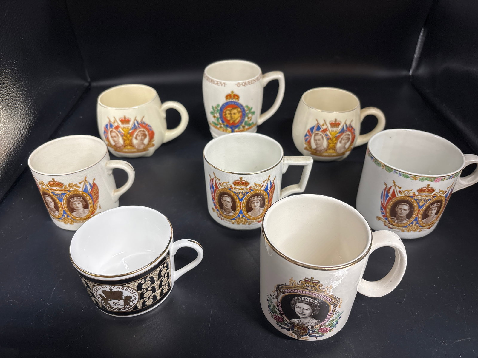 Group of eight similar Queen Elizabeth II commemorative mugs: Group of eight Queen Elizabeth II commemorative mugs. vintage collectible is a 1937 commemorative mug celebrating the coronation of King George VI and Queen Elizabeth. Design: Features a royal crest w