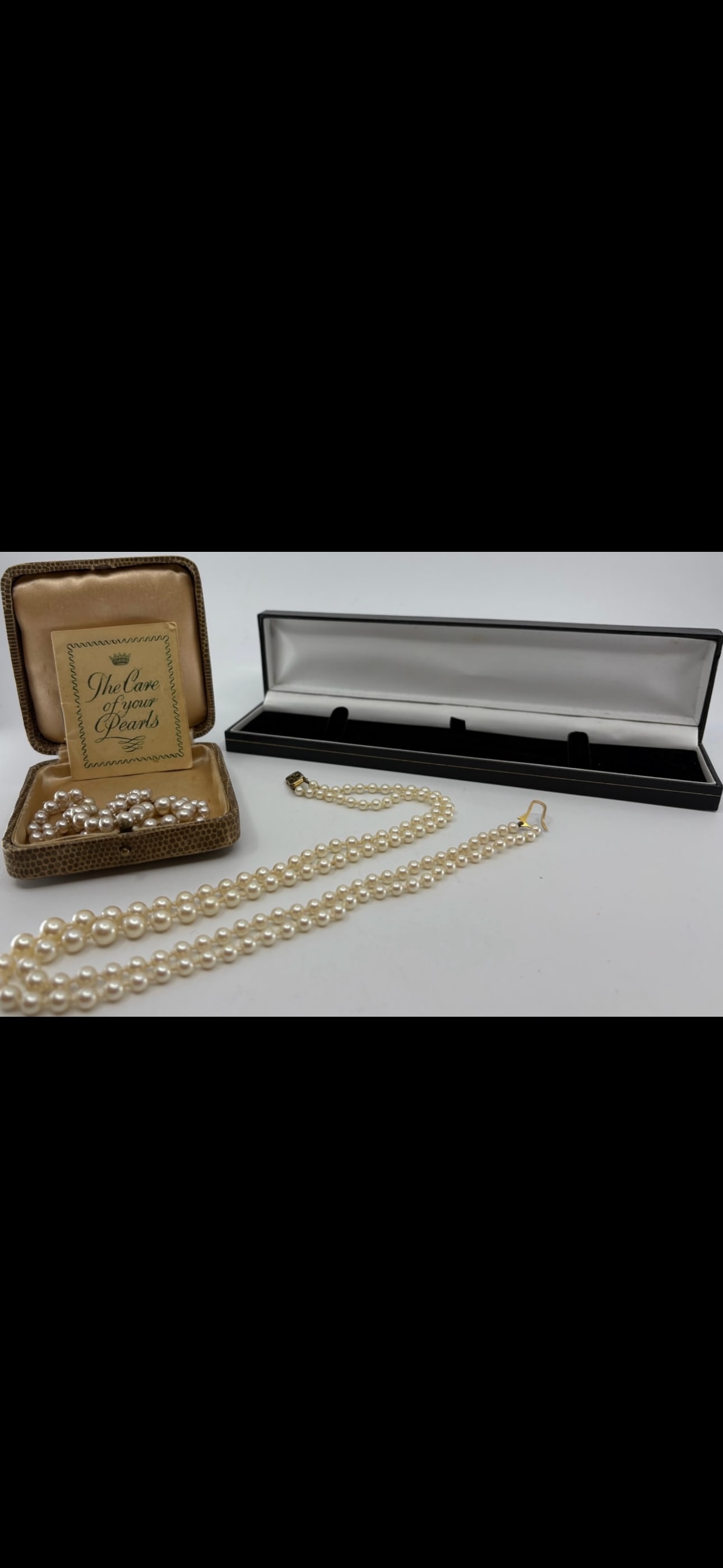 Two English 9 k gold clasped pearl & simulated pearl necklaces: A simulated two stranded pearl necklace with "375" hallmarked 9ct gold clasp boxed and a Ciro simulated pearl choker necklace with "9CT CIRO" stamped 9ct gold clasp with original box and paperwork