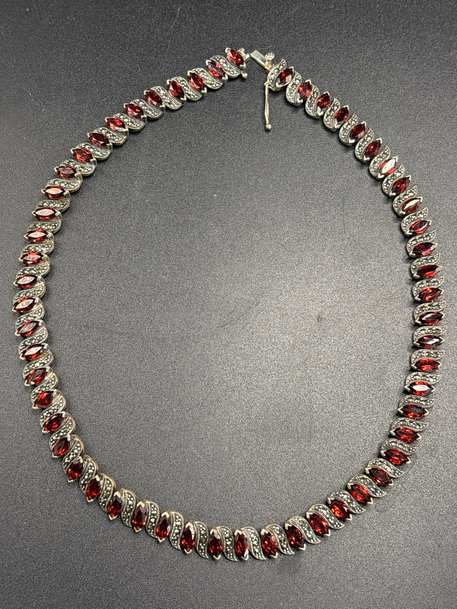 Gorgeous 34 inch sterling silver Marcasite and Red Gemstone (Garnet?) Necklace: Gorgeous 34 inch sterling silver Marcasite and Red Gemstone Tennis Necklace (or bracelet).Key Features and IdentificationThe item features a distinctive Art Deco-inspired design characterized by:Gemst
