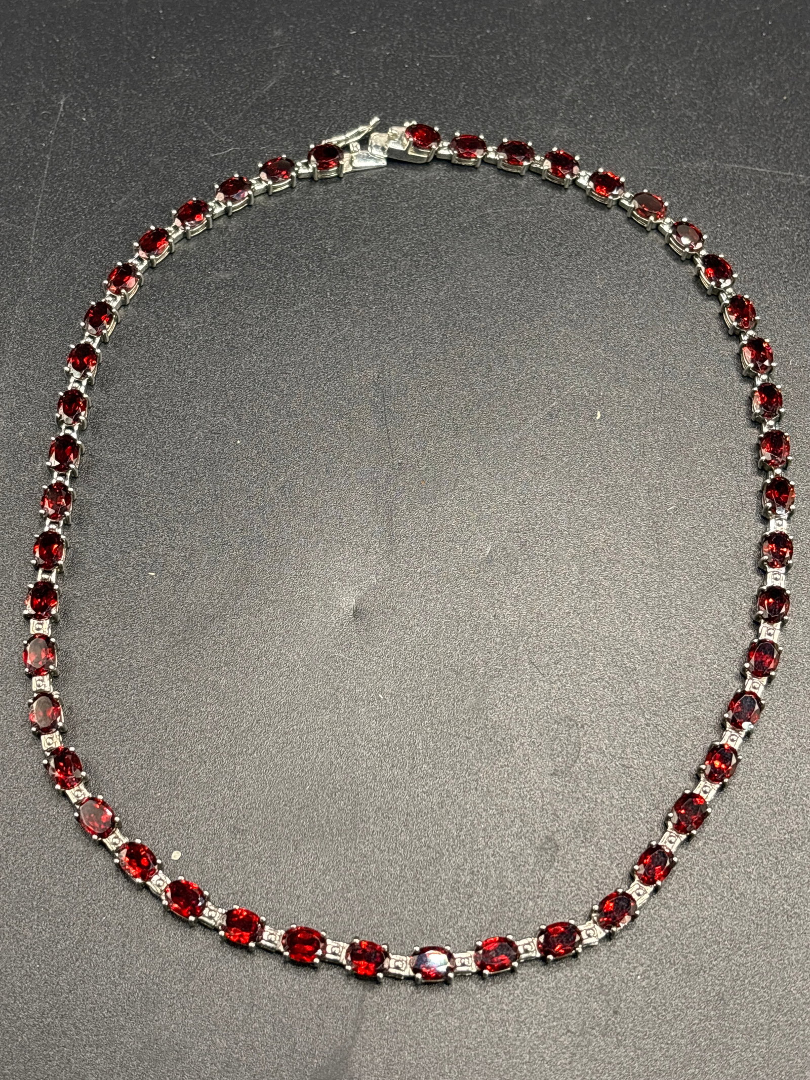 Beautiful sterling silver 34 inch red gemstone (rubies?) tennis necklace: Beautiful 34 inch red gemstone tennis necklace, likely featuring either natural garnets or lab-created rubies set in sterling silver. These necklaces typically consist of a continuous strand of