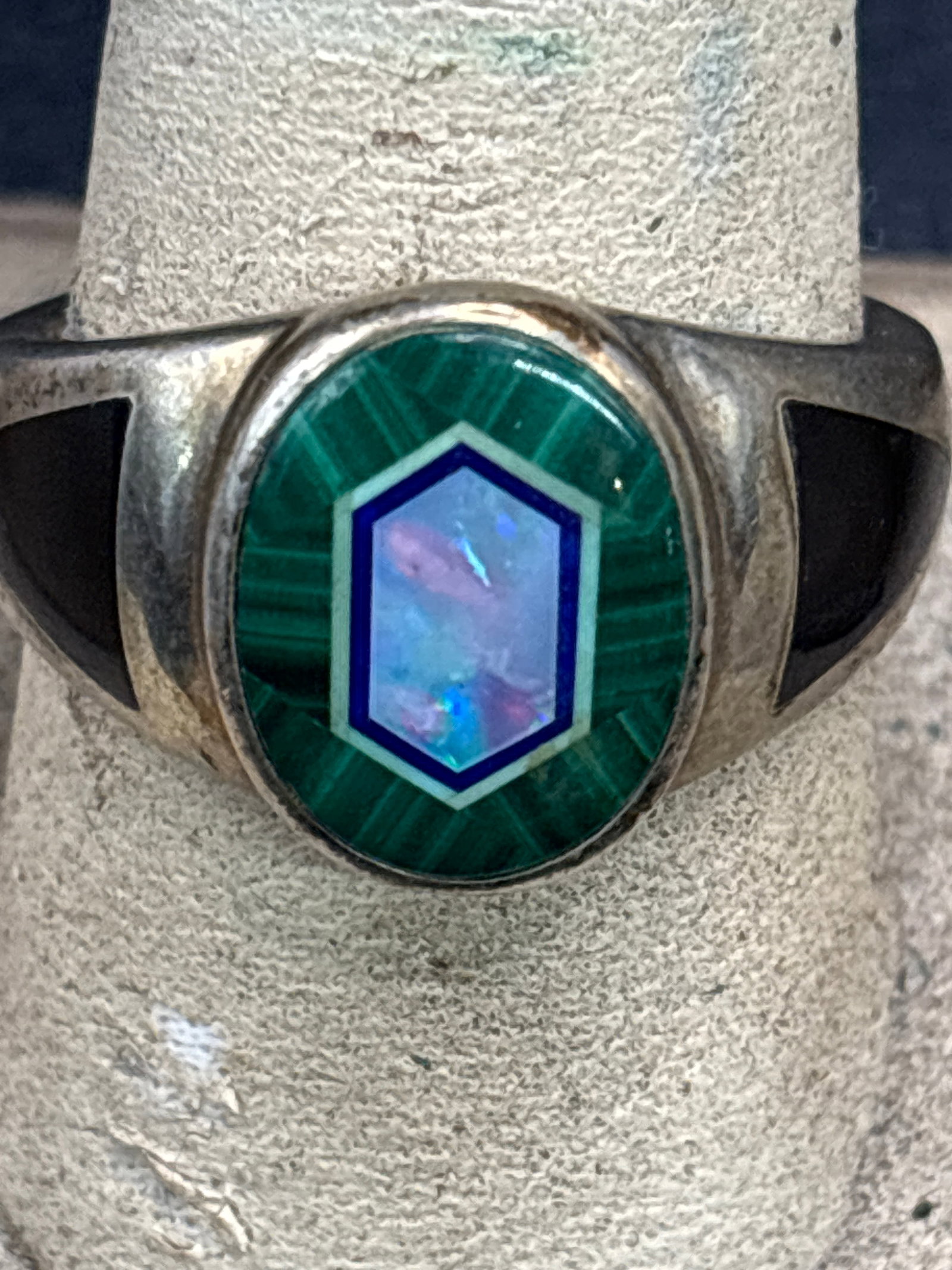 vintage 925 sterling silver statement piece ring designed by Whitney Kelly: vintage 925 sterling silver statement piece ring designed by Whitney Kelly . The centerpiece features a distinctive multi-stone inlay design:Malachite: The outer green stone with natural banded