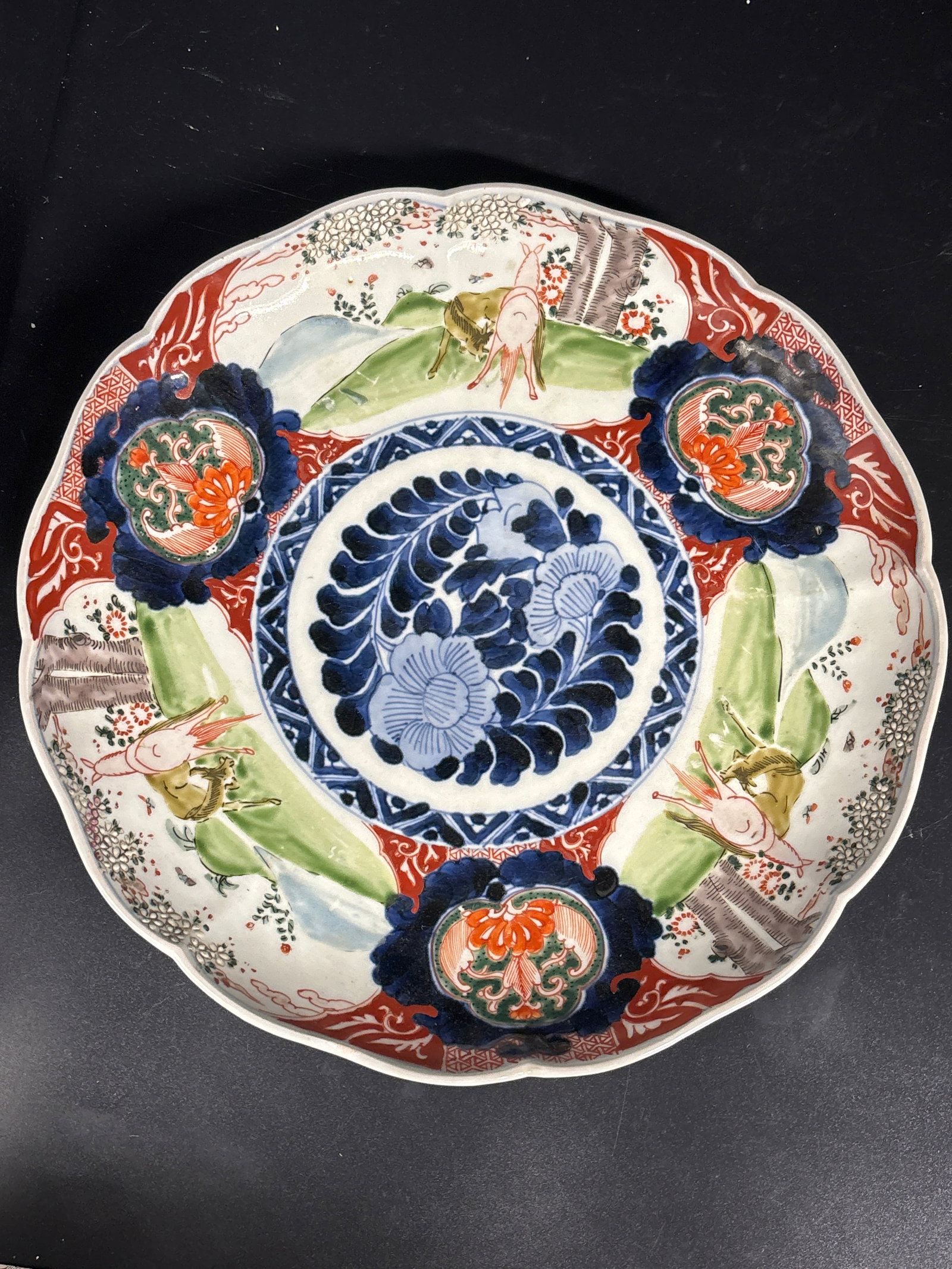 Japanese Imari porcelain charger 11&1/4 inch plate: Japanese Imari porcelain charger plate, likely originating from the 19th century Meiji period. Design: It features a traditional scalloped edge with vibrant hand-painted floral, scenic, or landscape p