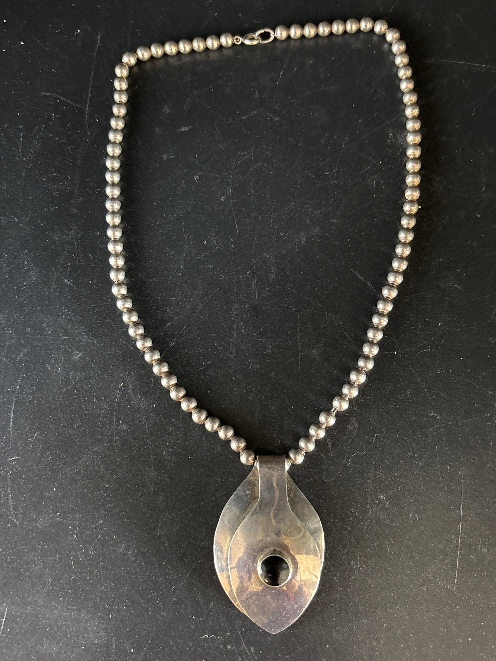 Sterling silver 26 grams 16 inches modernist sterling silver pendant necklace: Sterling silver 26 grams 16 inches. modernist sterling silver pendant necklace, likely of Mexican or Southwestern origin. It features a distinctive sculptural leaf-shaped pendant (sometimes called a "