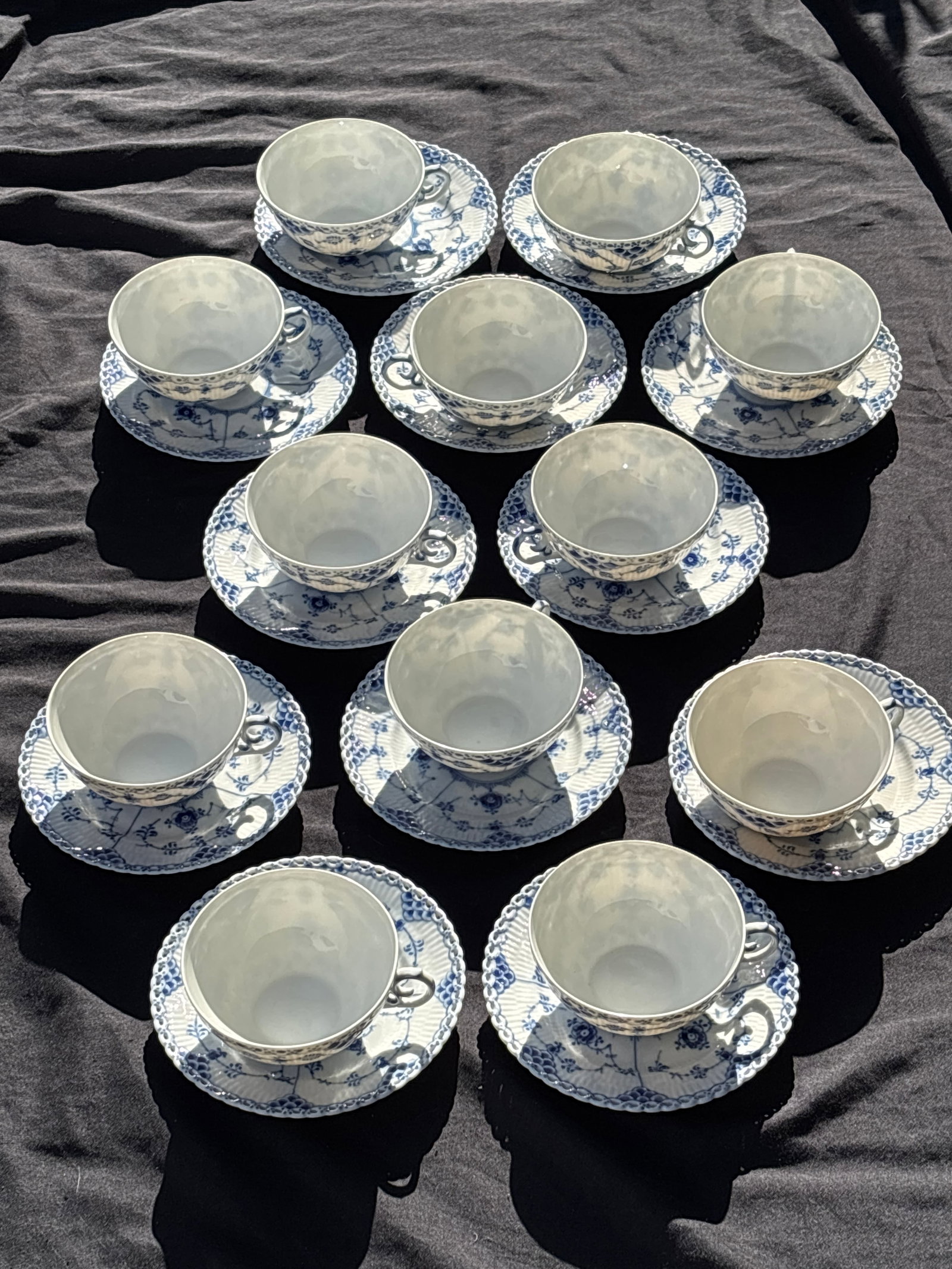 Set of twelve cups & saucers Royal Copenhagen Blue Fluted Lace: Set of twelve cups & saucers Royal Copenhagen Blue Fluted Lace, one of the most famous and enduring porcelain designs in the world.Pattern HighlightsDesign Origin: Introduced in 1888, it's an evolutio