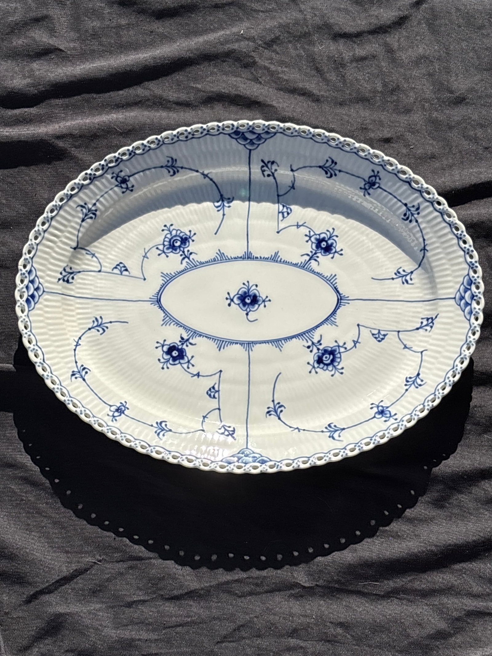 Royal Copenhagen Blue Fluted Full Lace 14&1/4 inch platter#1148: large 14&1/4 inch platter Royal Copenhagen Blue Fluted Full Lace , number 1148…a prestigious line of Danish porcelain.Key FeaturesIntricate lace-like rim with delicate perforations.Hand-painted coba
