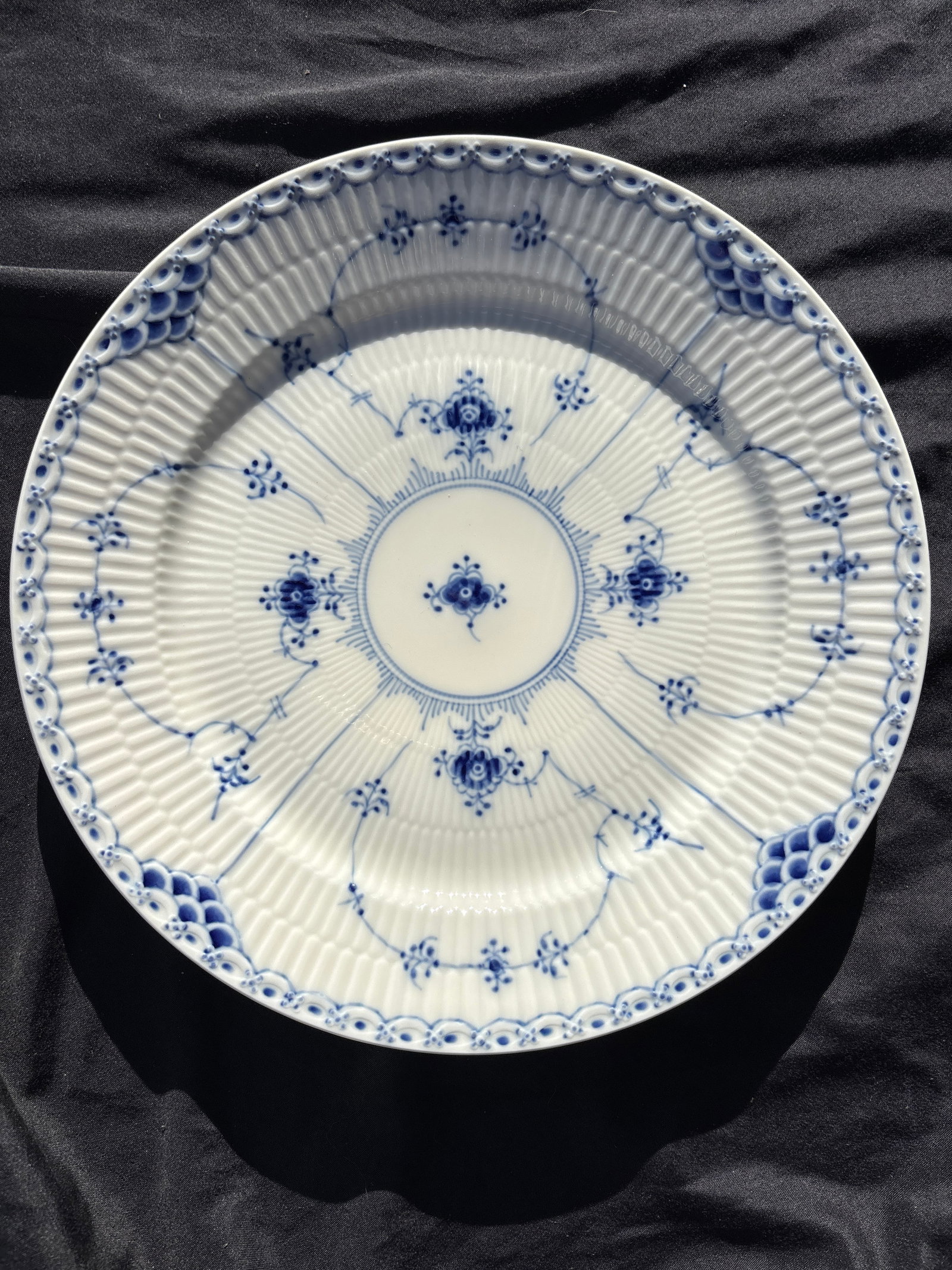 Royal Copenhagen Blue Fluted Half Lace 10&7/8inch chop plate #627: Royal Copenhagen Blue Fluted Half Lace 10&7/8 round chop plate number 627…a prestigious line of Danish porcelain.Key FeaturesIntricate lace-like rim with delicate perforations.Hand-painted cobalt bl