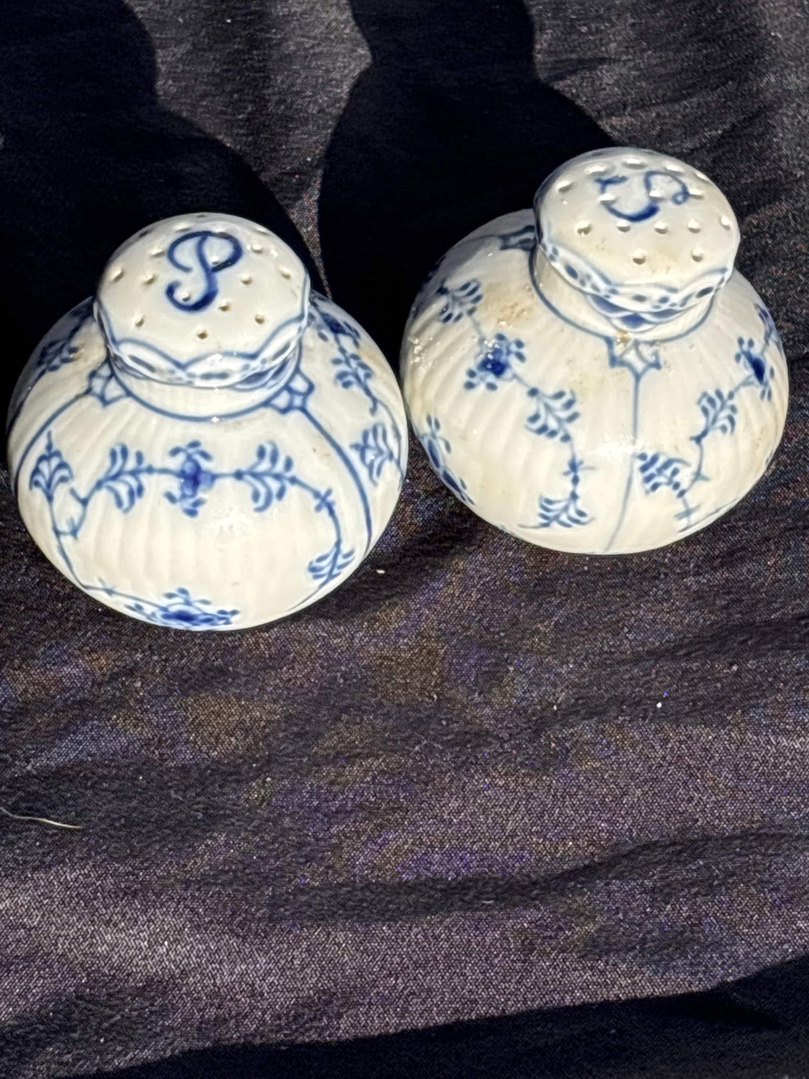pair Royal Copenhagen Blue Fluted Full Lace 2&1/2 in salt & pepper 711&712: Royal Copenhagen Blue Fluted Full lace salt & pepper shakers number 711& 712…a prestigious line of Danish porcelain.Key FeaturesIntricate lace-like rim with delicate perforations.Hand-painted cobalt
