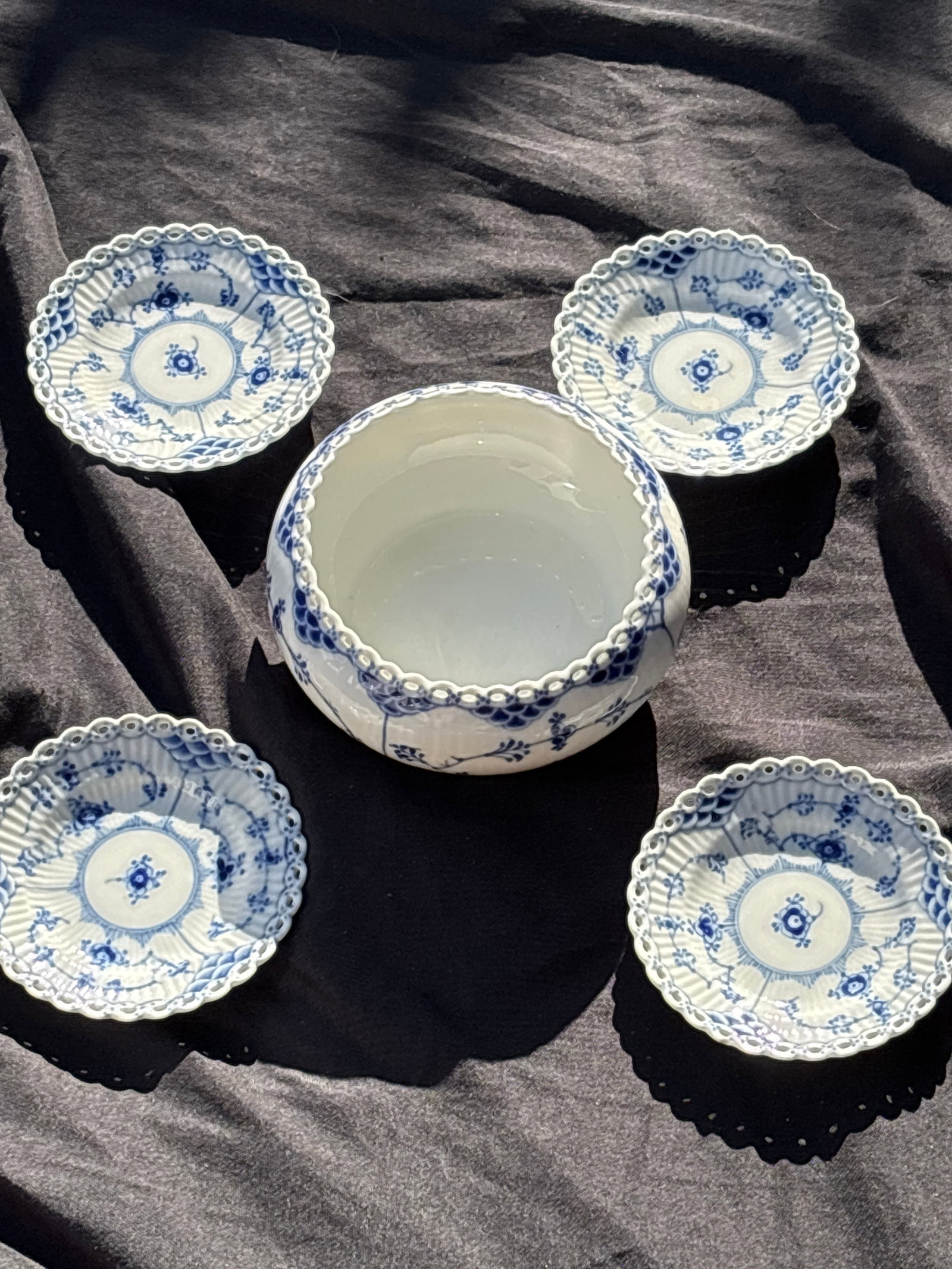 four 4&1/4 inch plates &a bowl Royal Copenhagen Blue Fluted Full Lace #1145,1183: Set of four small 4&1/4 inch plates/ & a 6 inch wide bowl Royal Copenhagen Blue Fluted Full lace; prestigious line of Danish porcelain.Key FeaturesIntricate lace-like rim with delicate perforations.Ha
