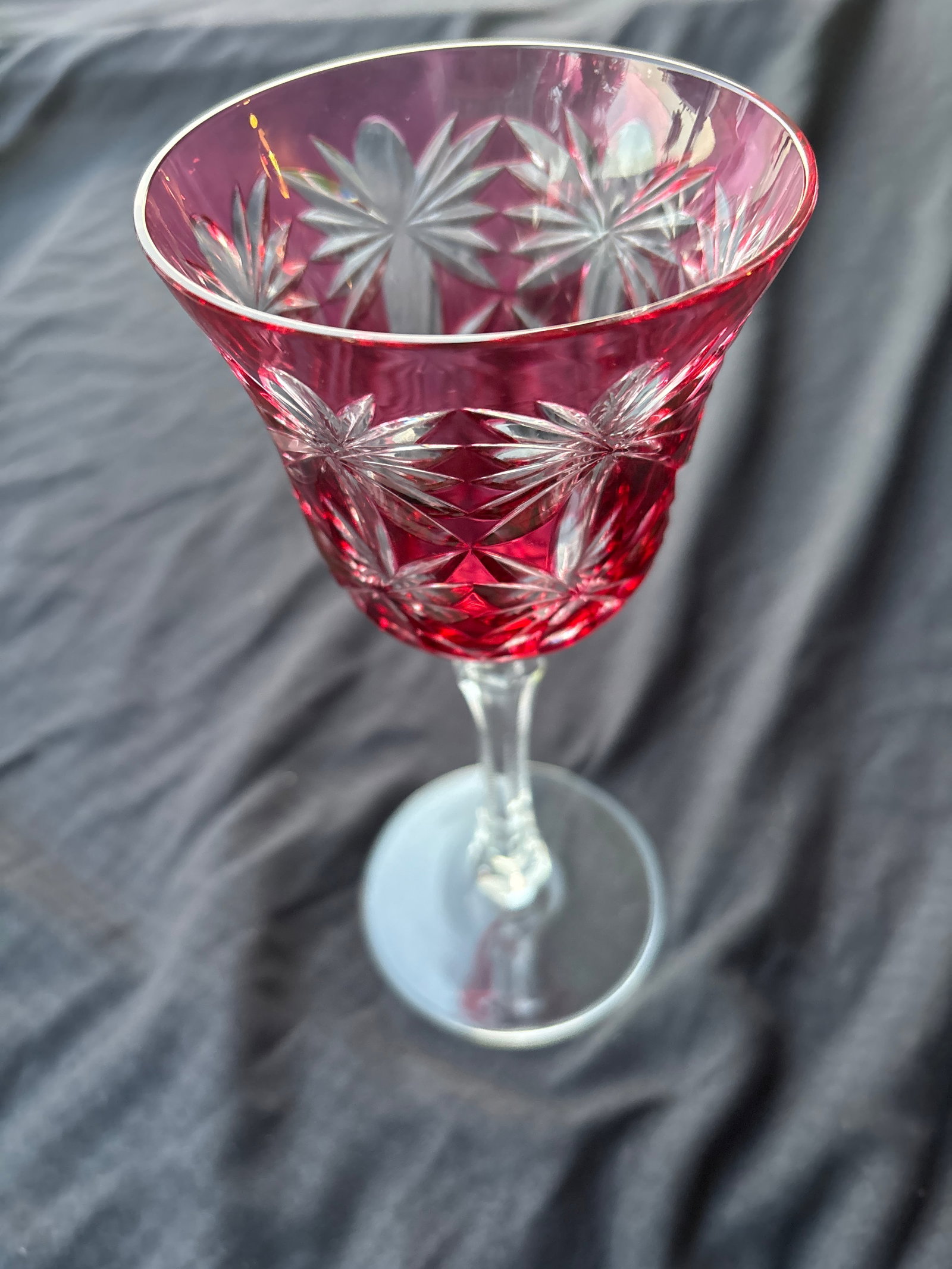 Unsigned cranberry red crystal goblets cut-to-clear crystal 8&3/8 inch wine hocks: cranberry red crystal wine goblets featuring a cased cut-to-clear pattern.Design Details: The glasses have a deep red overlay that has been wheel-cut to reveal clear glass underneath, forming intricat