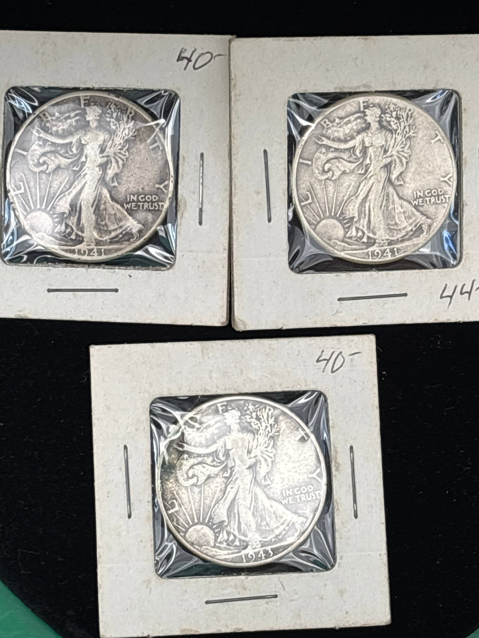 Three silver 1941 Walking Liberty half dollars.: Three 1941 Walking Liberty half dollars.This coin is composed of 90% silver and 10% copper, with a total silver weight of approximately 0.36 troy ounces.It features Lady Liberty striding toward a risi