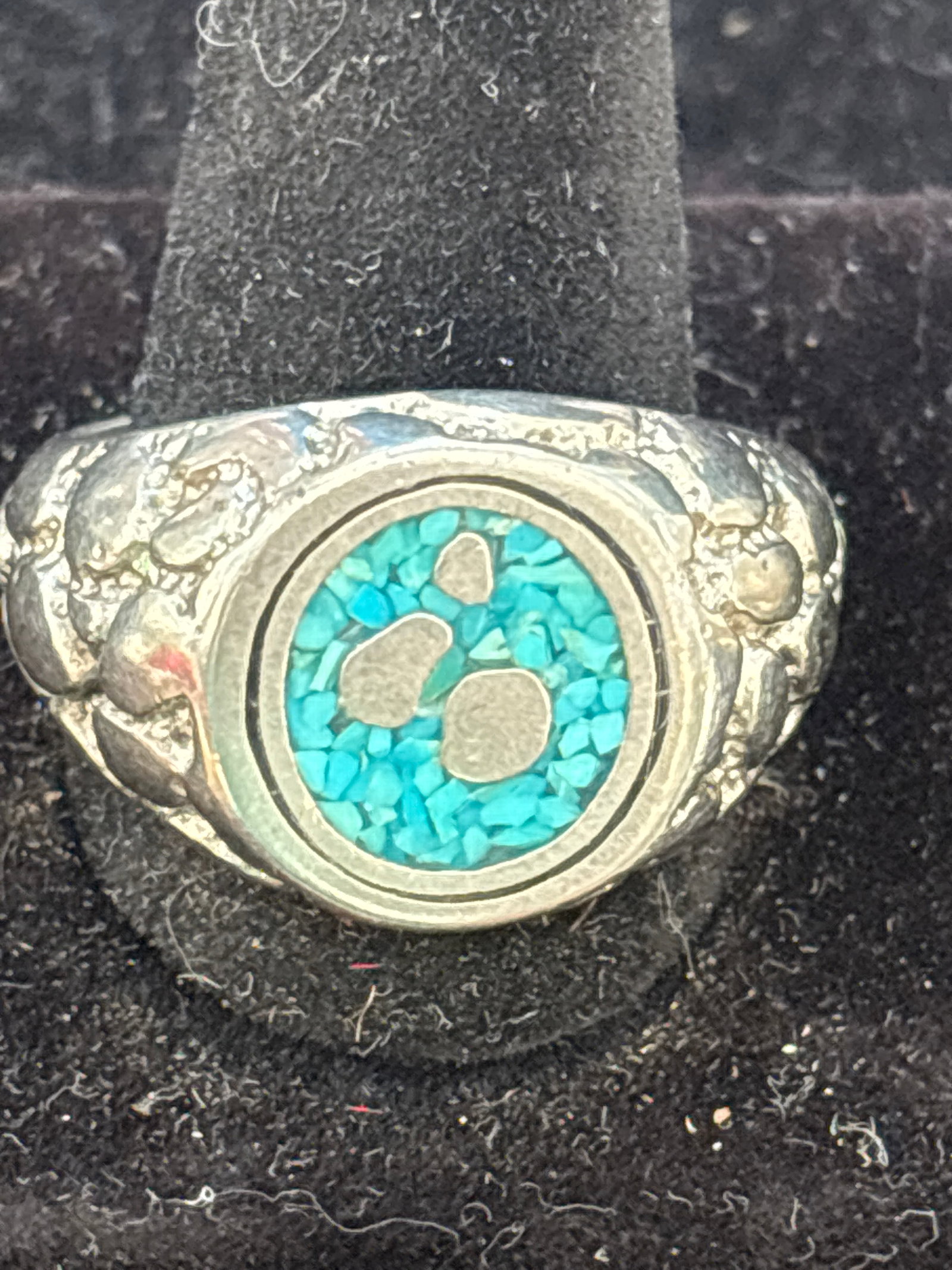 Native American turquoise & silver ring; 13 grams: Native American inspired sterling silver and turquoise ring.The design frequently resembles work by Zuni artist Effie Calavaza, often featuring snake motifs alongside turquoise stones.It typically inc