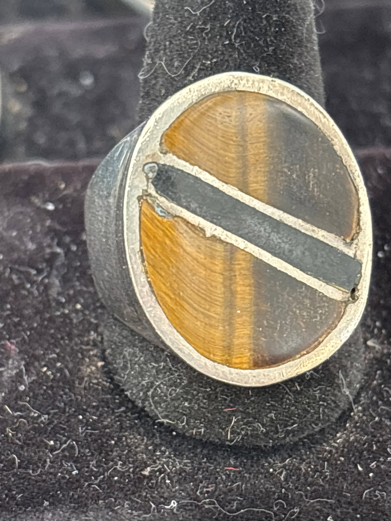 Heavy Navajo handcrafted sterling silver & Tiger Eye ring; 22 grams: Navajo handcrafted sterling silver ring featuring a multi-stone inlay design. The geometric pattern is a hallmark of Native American jewelry, specifically from the Navajo tribe.Ring DetailsMaterials: 