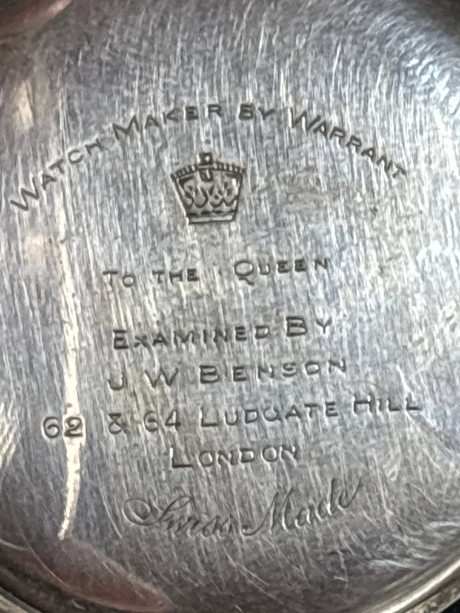 antique .935 silver London Victorian-era hunter caspocket watch: image shows the inner back casing of an antique J.W. Benson pocket watch.The engraving indicates the watch was authorized by the Queen and manufactured by J.W. Benson at 62 & 64 Ludgate Hill, London.W