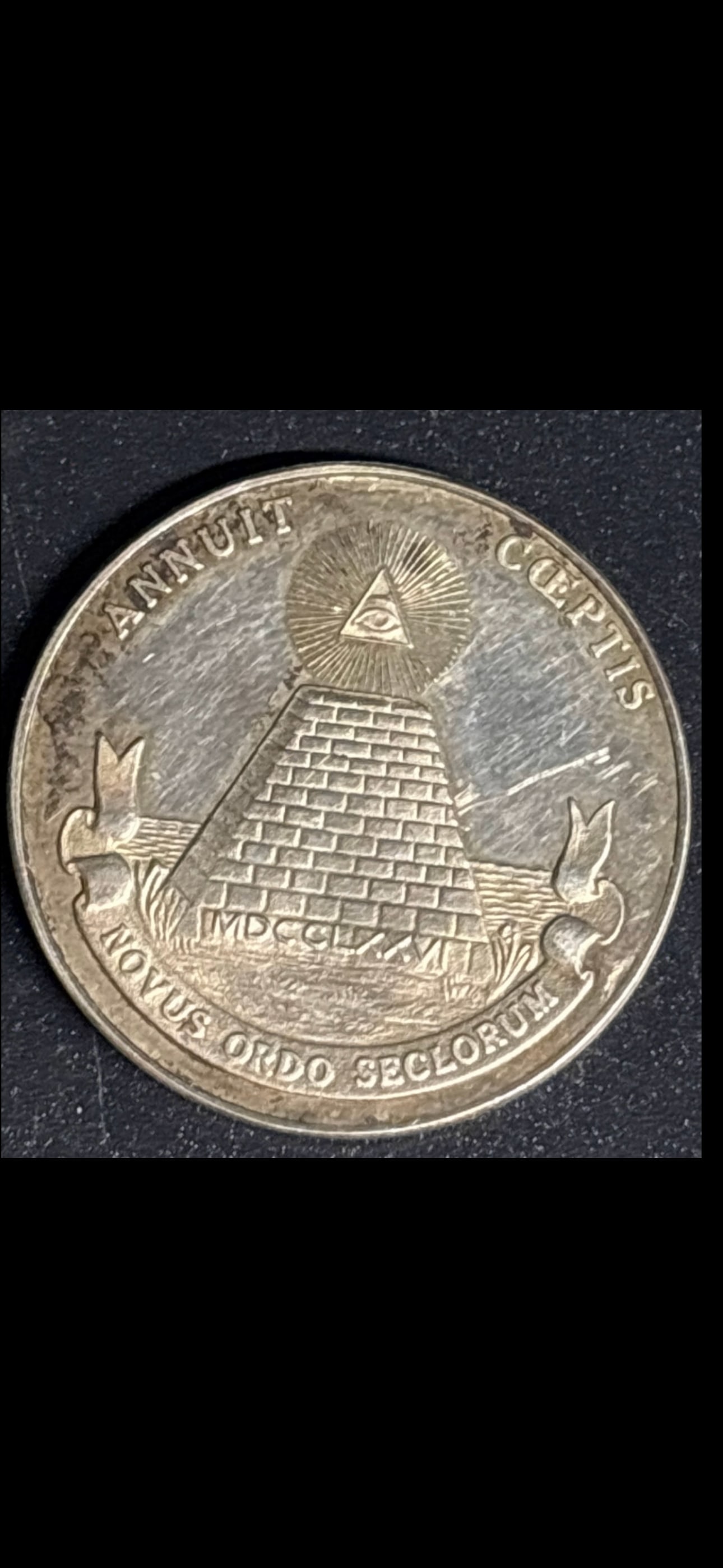 Sterling silver token featuring the reverse side of the Great Seal of the United States: Sterling silver token featuring the reverse side of the Great Seal of the United States, commonly known as the Eye of Providence or the pyramid from the one-dollar bill. Design: An unfinished pyramid 