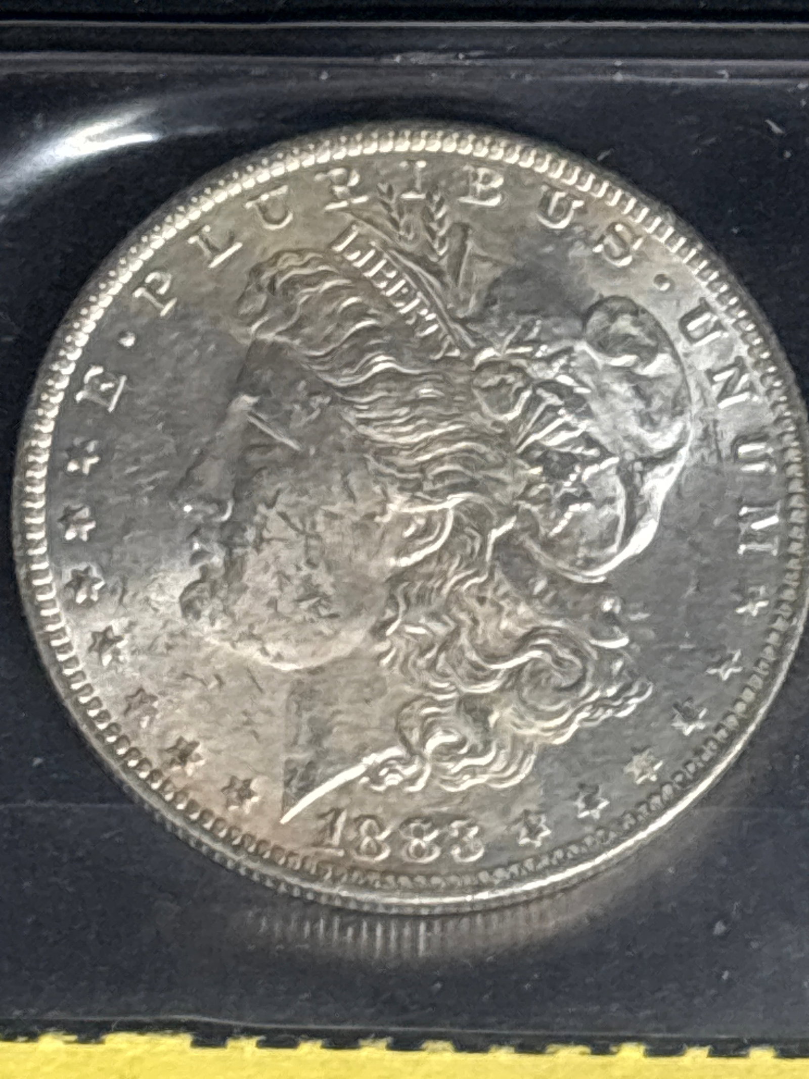 Early 1883 United States Morgan Silver Dollar.: Early 1883 United States Morgan Silver Dollar. Design and Year: The coin features Lady Liberty on the obverse and is dated 1883.Composition: Morgan dollars are composed of 90% silver and 10% copper.Hi
