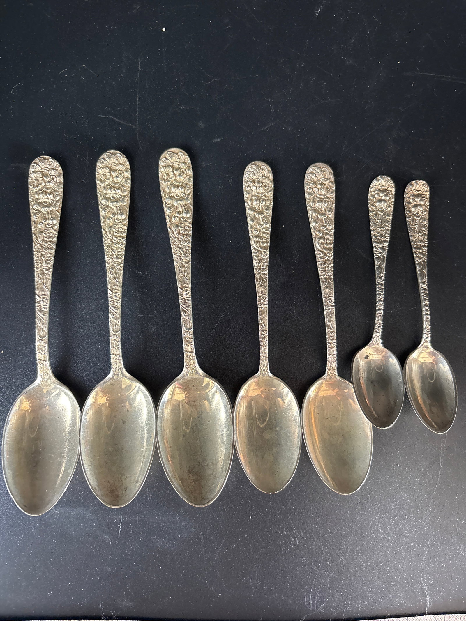 Seven Stieff Repousse sterling silver tea spoons;180 grams: Five 5&7/8 inch, two 5&1/2 & two 4&1/4 inch sterling silver spoons. These two patterns are very similar, both featuring an ornate, embossed "repousse" style that originated in Baltimore.Product Detail