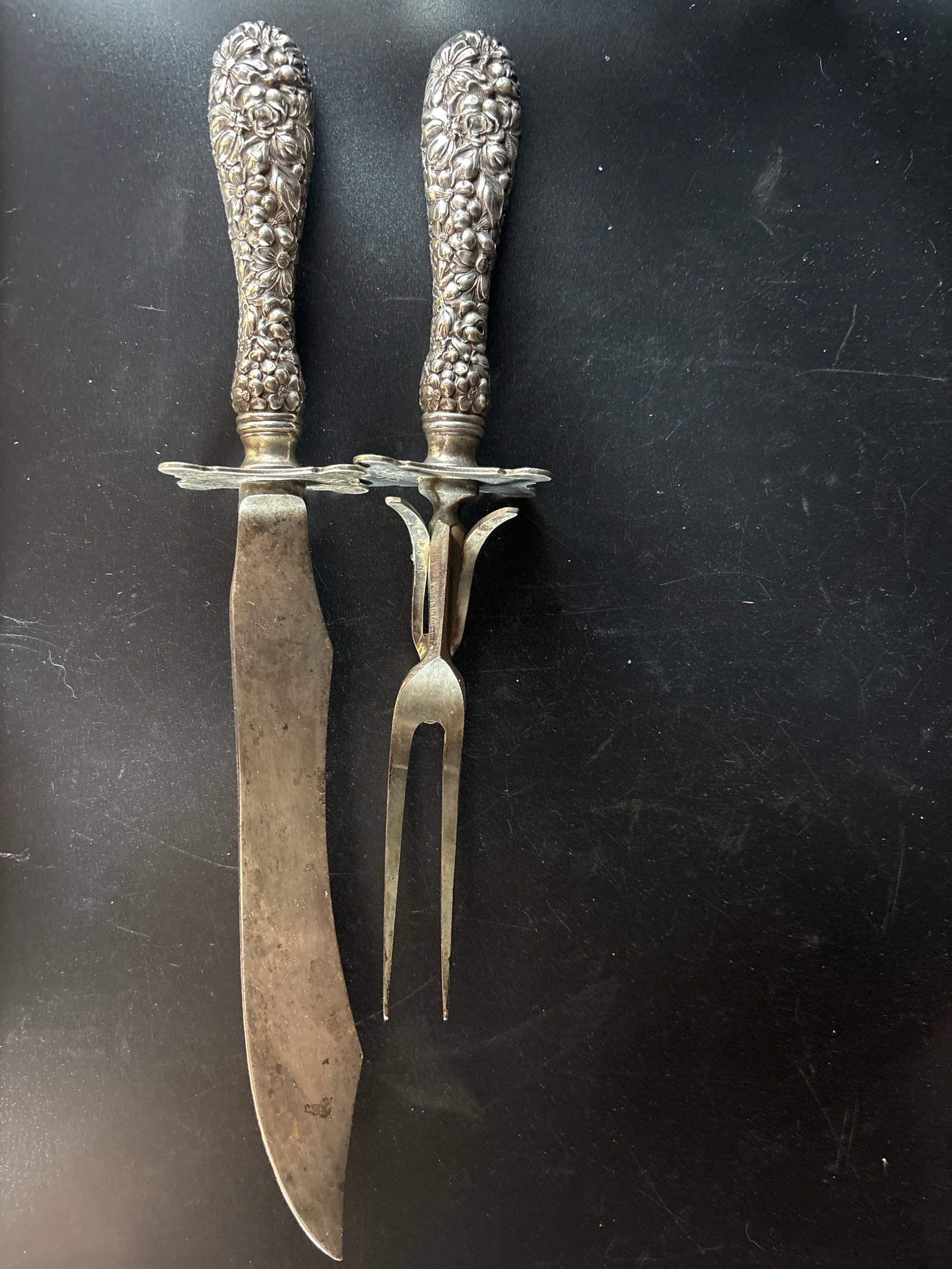 Two piece carving set sterling handled Stieff Rose pattern: Two piece carving set Stieff Rose pattern featuring ornate sterling silver handles and stainless steel blades.Pattern Details: The handles are decorated with a high-relief chased floral design charact