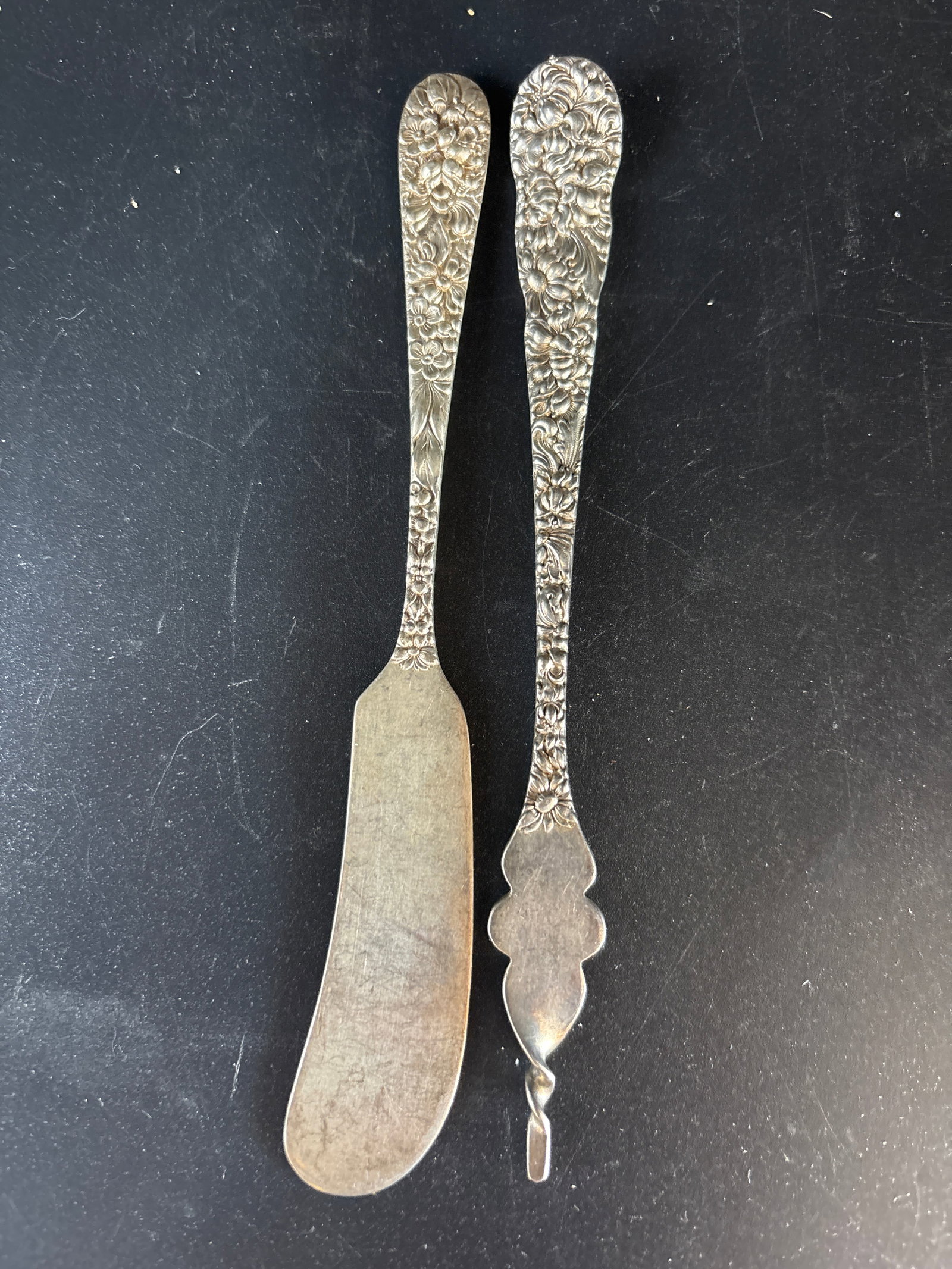 Butter pick & butter knife sterling handled Stieff Rose pattern;53 grams: Stieff Rose pattern featuring ornate sterling silver handles and stainless steel blades.Pattern Details: The handles are decorated with a high-relief chased floral design characteristic of the Baltimo