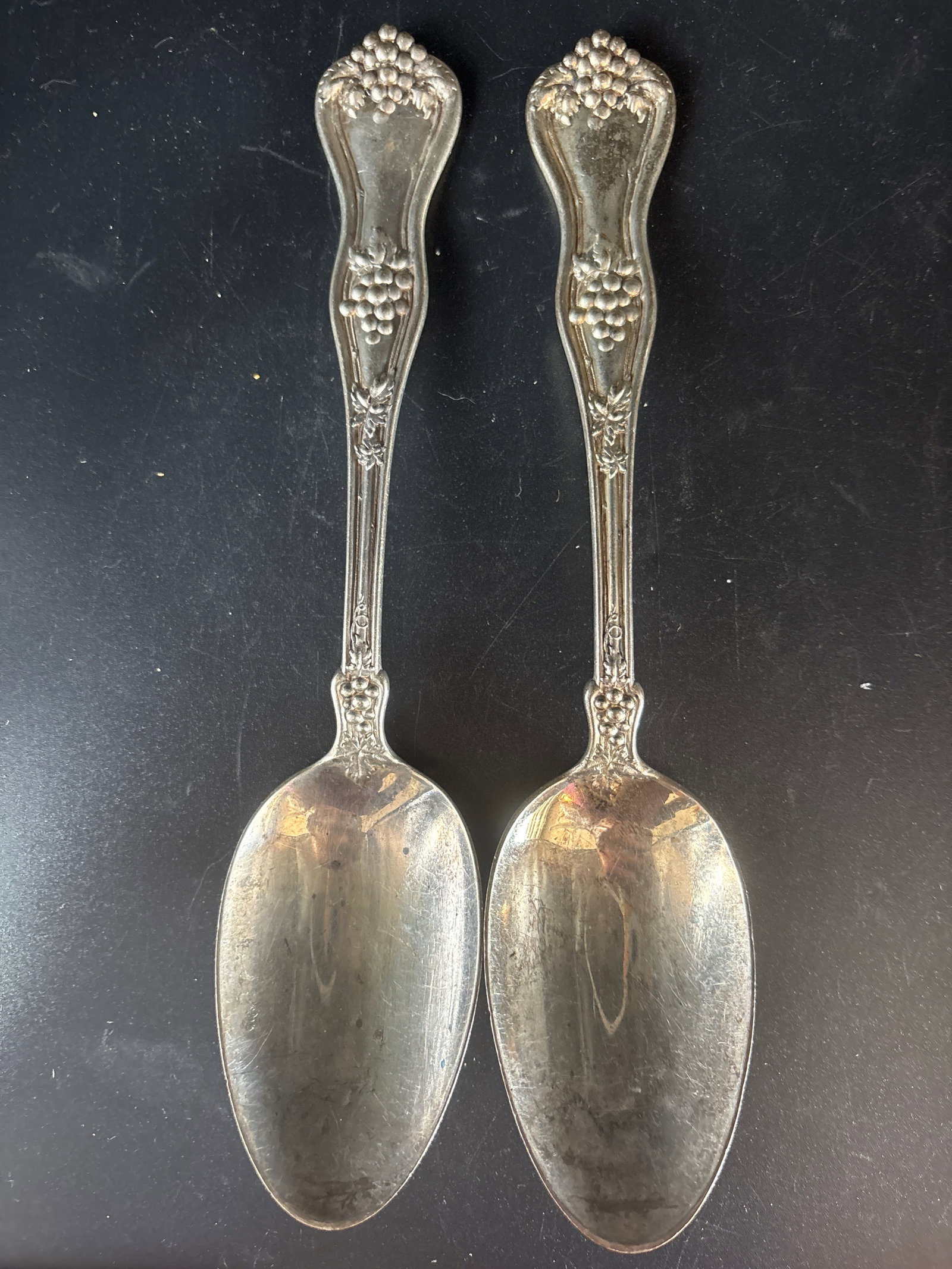 Pair Large 8&1/4 in Pat.1885 sterling silver serving spoons, grape motifs;160 grams: 160 grams, antique sterling silver serving spoons with grape motifs.Pattern and Manufacturer: The spoon features a distinctive motif on the handle, similar in style to the "Berry" pattern by Whiting M
